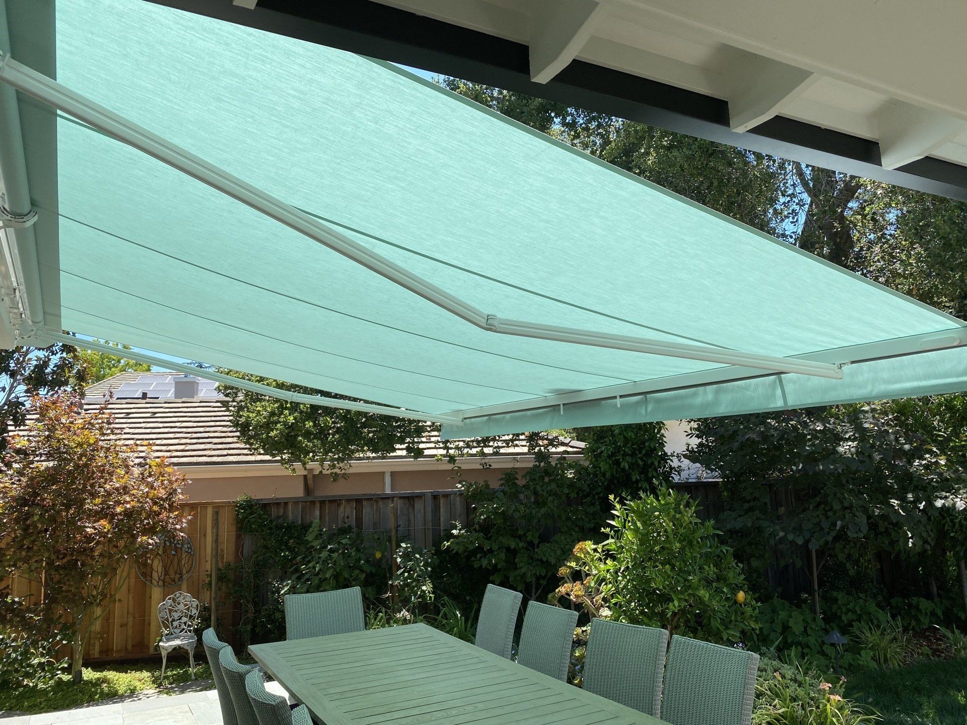 A patio with a table and chairs under an awning
