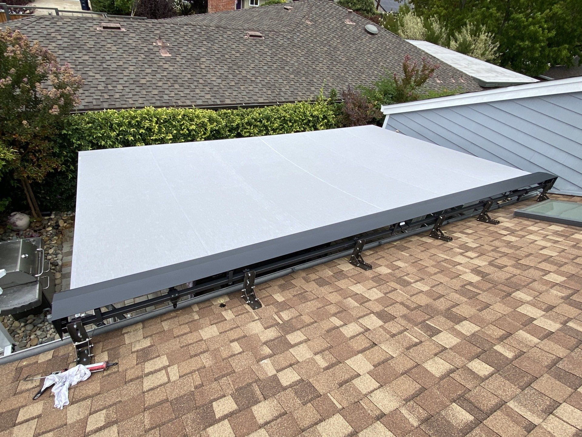 A solar panel is sitting on top of a brick roof.