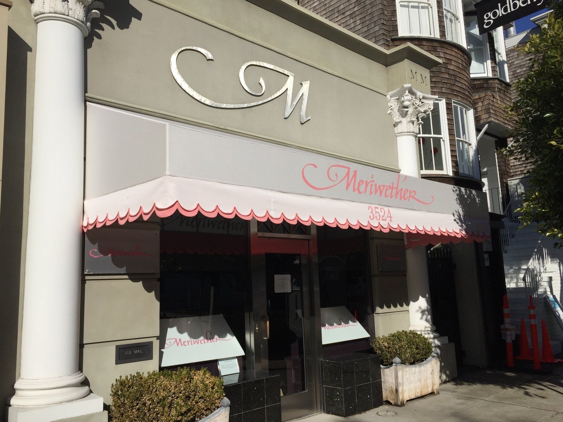 A store front with a pink awning that says mercantile