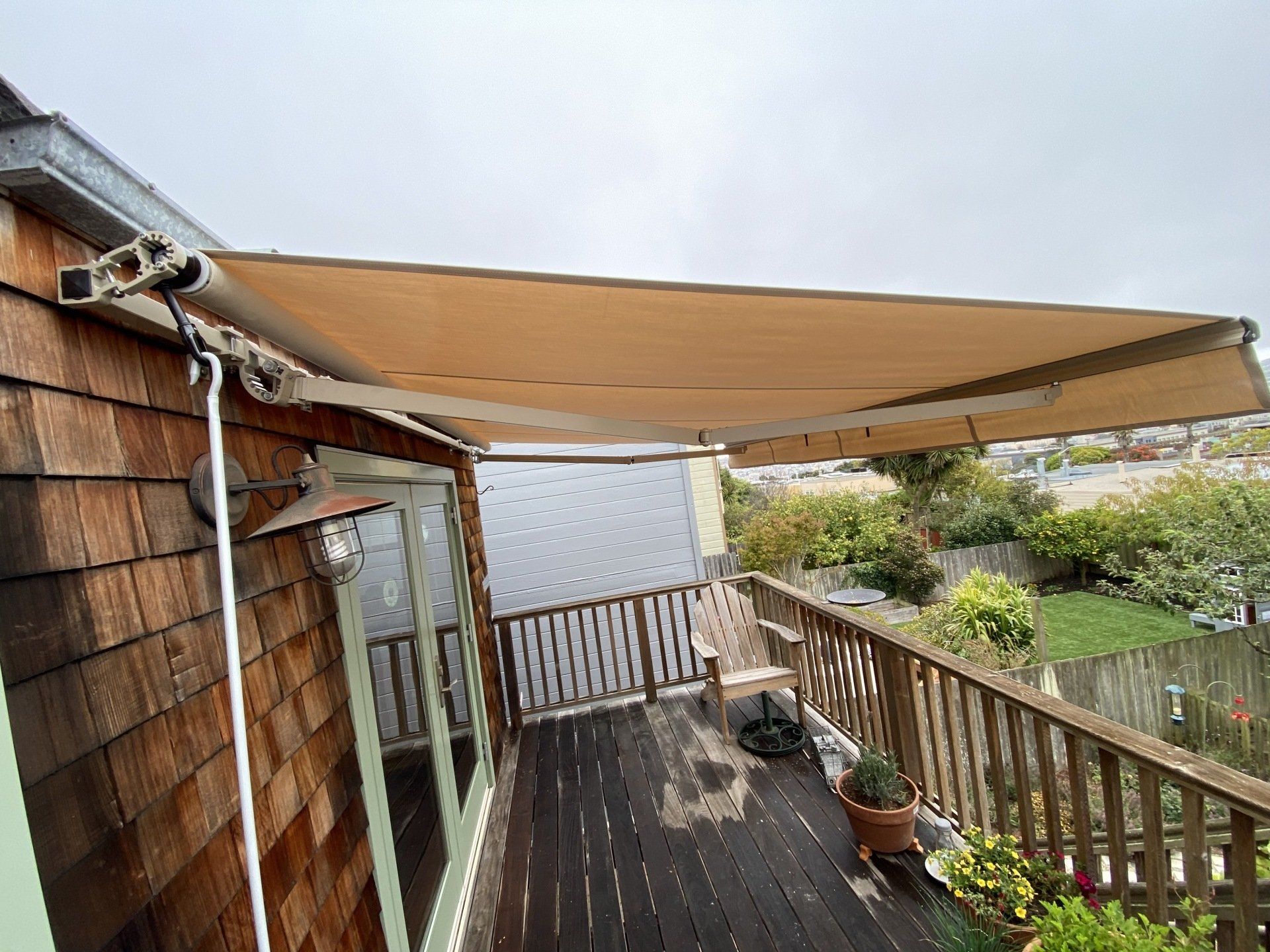 A deck with a canopy over it and a chair on it.