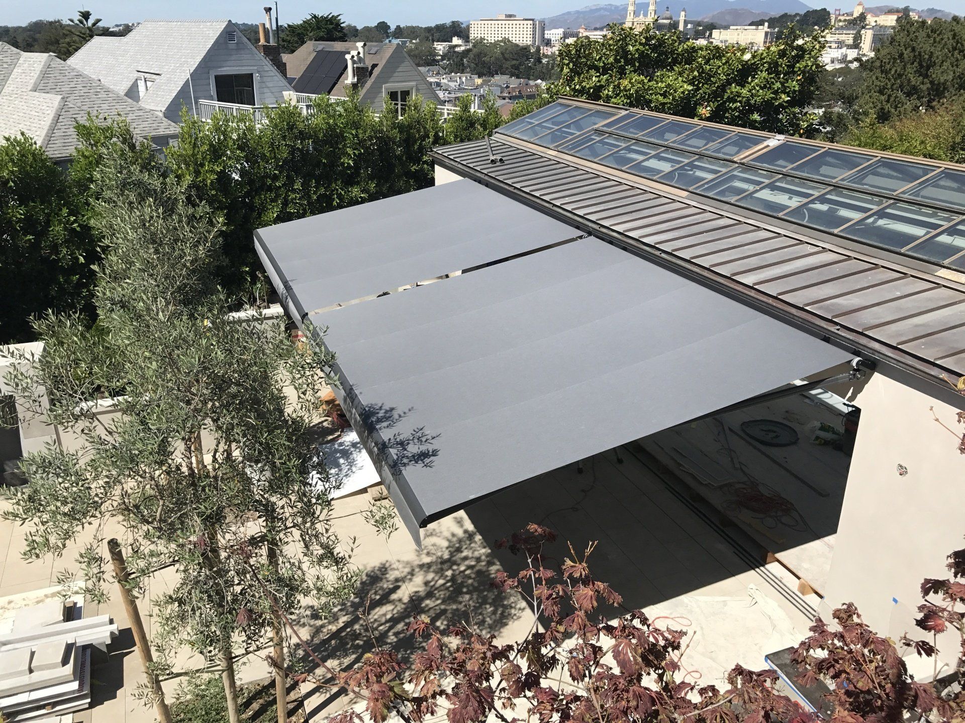 An aerial view of a house with a large awning on the roof.