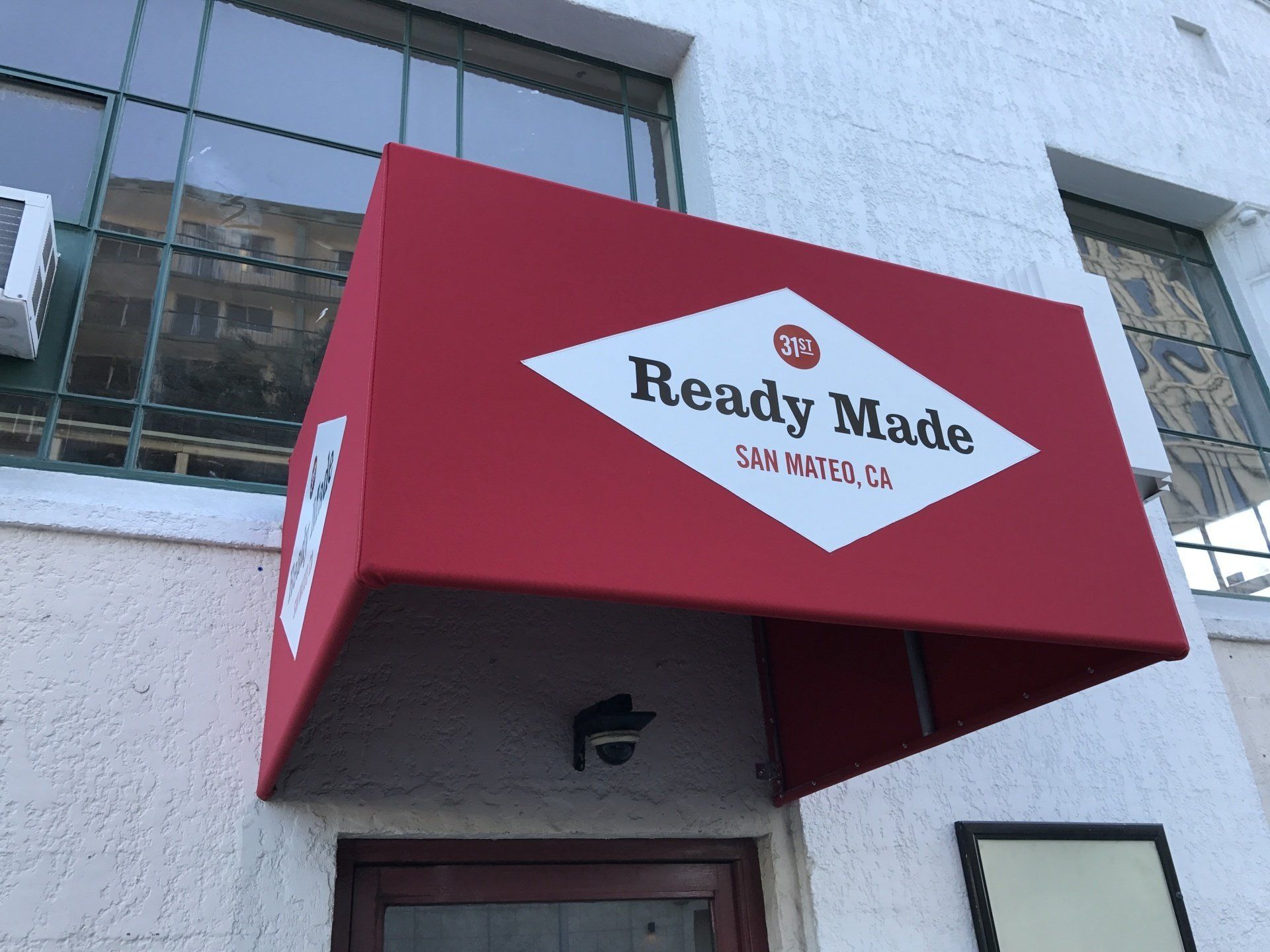 A red awning that says ready made on it