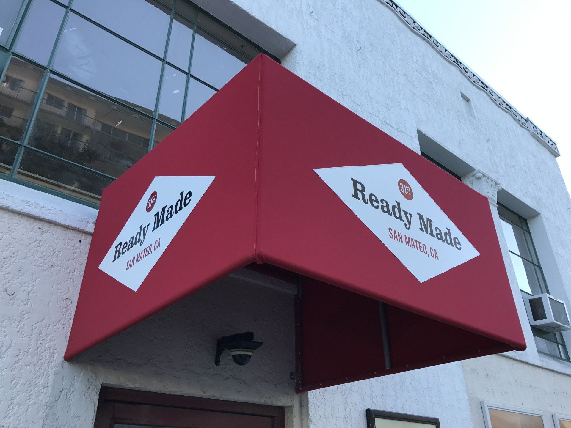 A red awning that says ready made on it