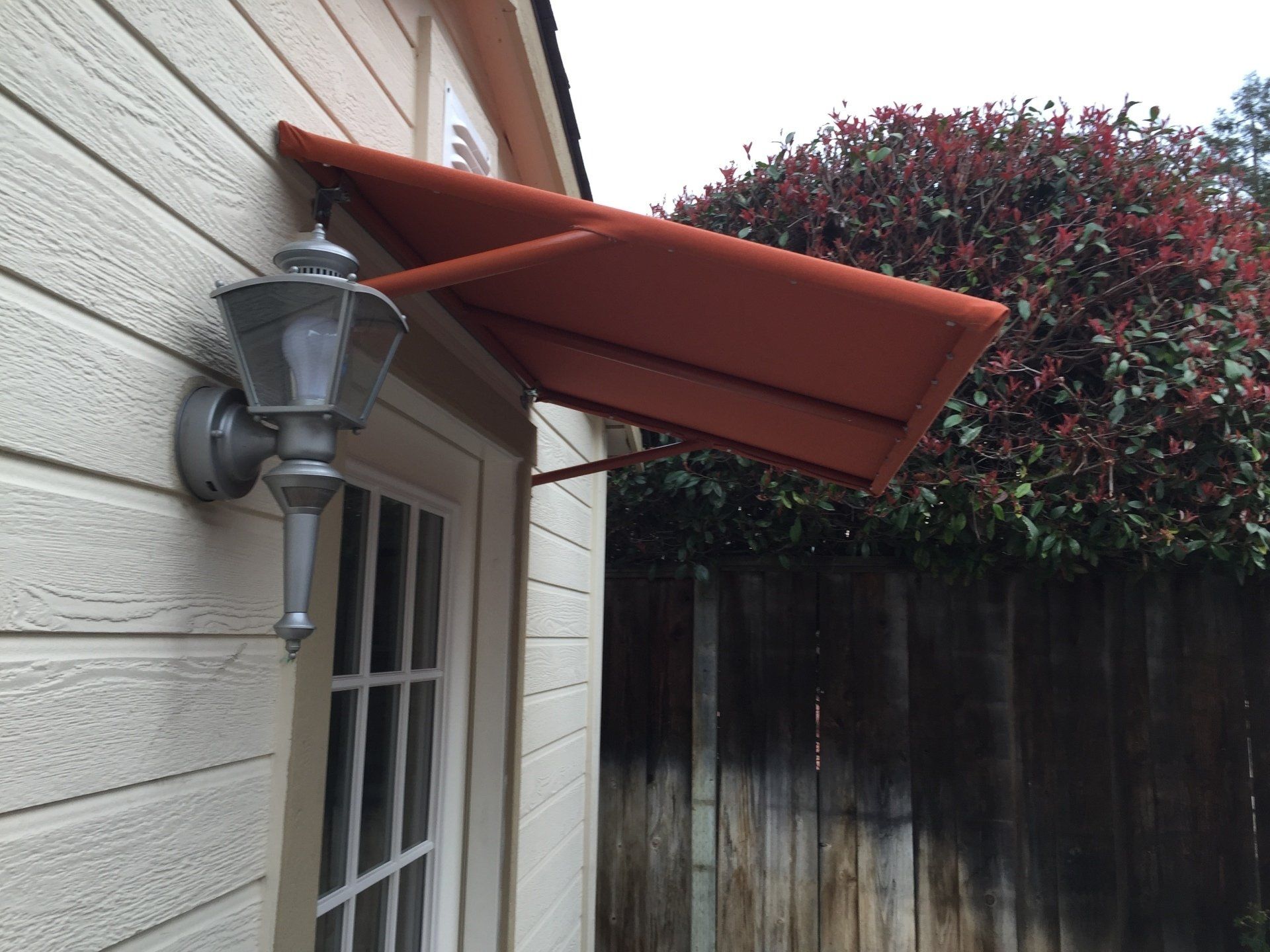 A canopy is attached to the side of a house