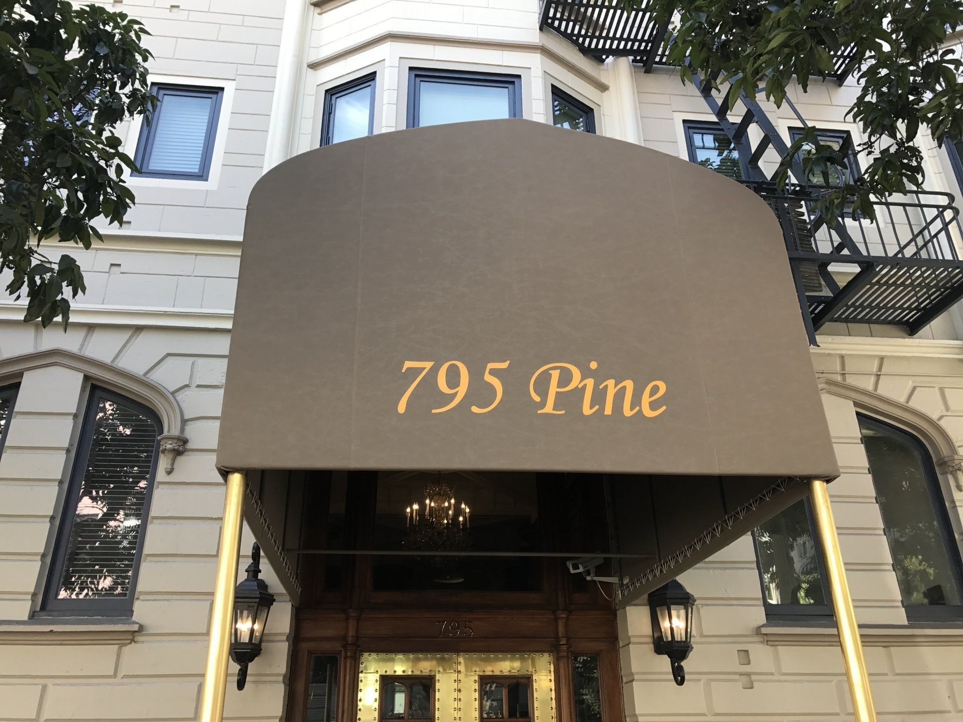 A building with a canopy over the entrance that says 795 pine