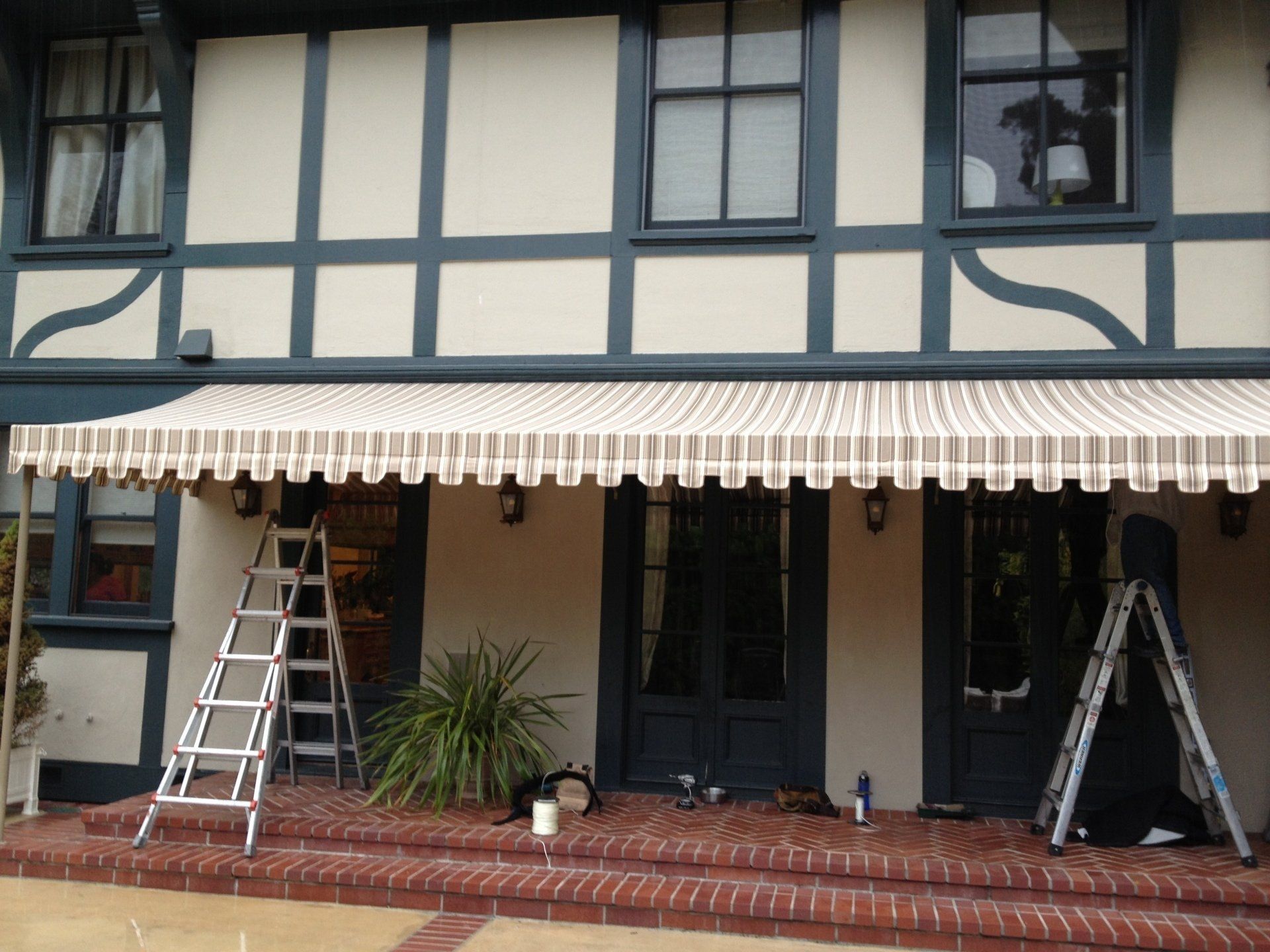 An awning is being installed on the front of a house