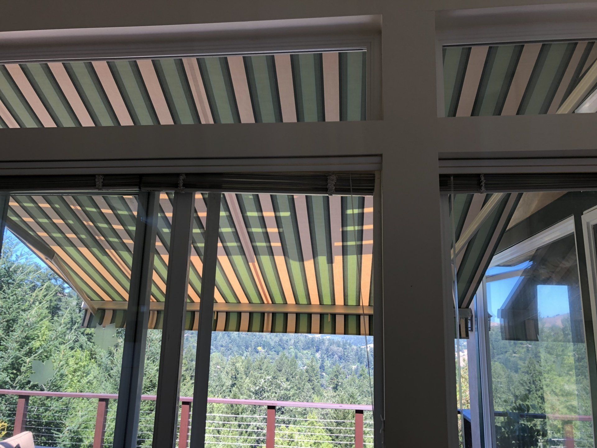 A window with a striped awning over it