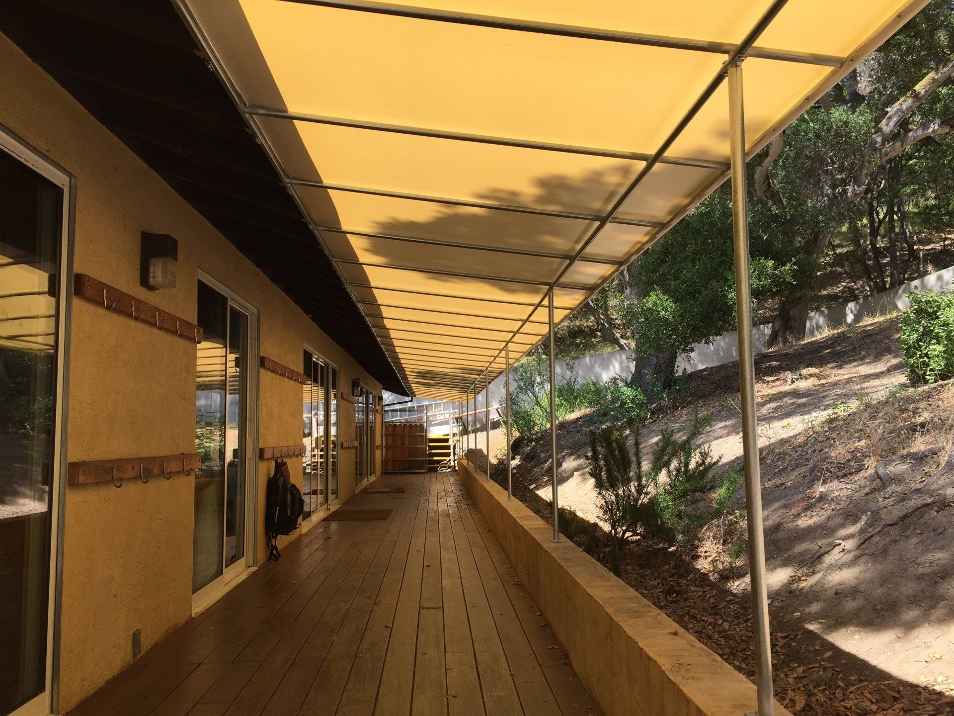 A long walkway with a yellow awning over it