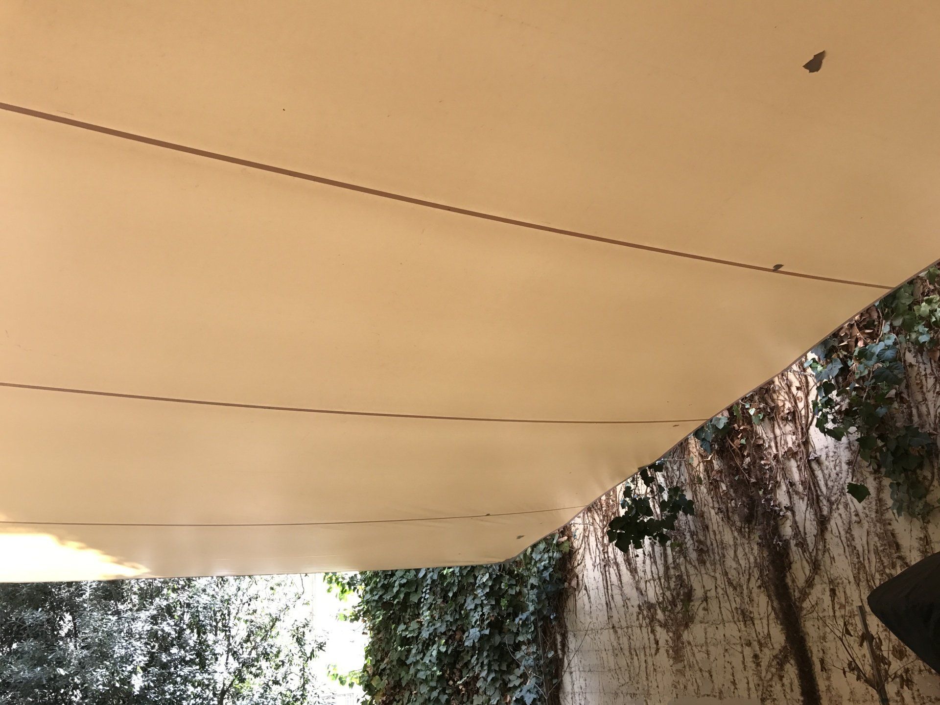 A white tarp is hanging from the ceiling of a building.