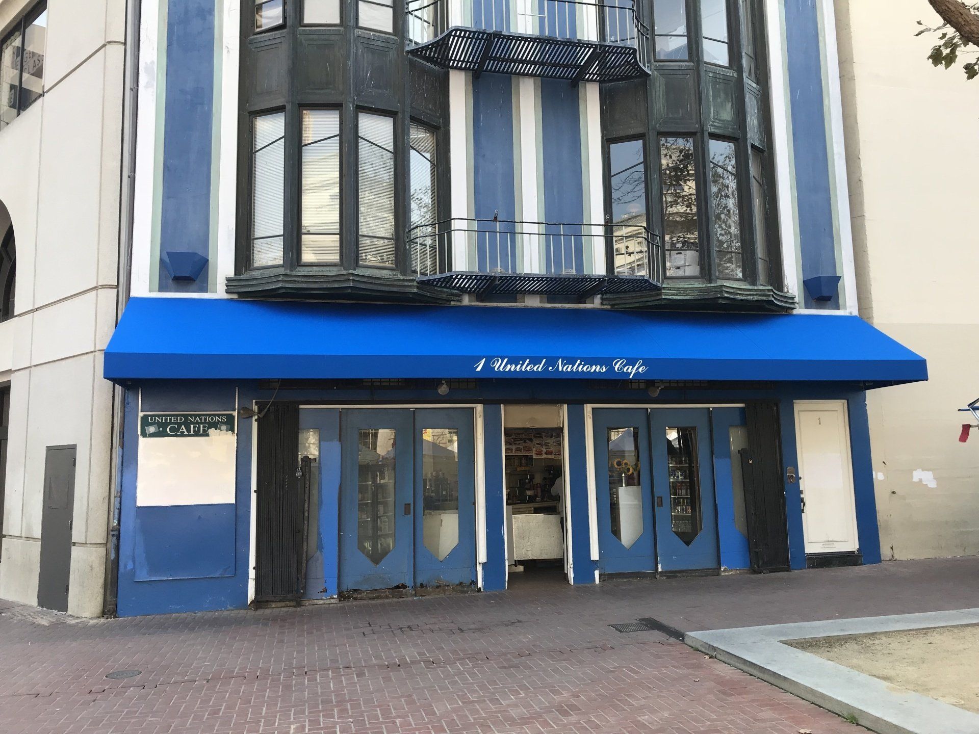 The front of a building with a blue awning