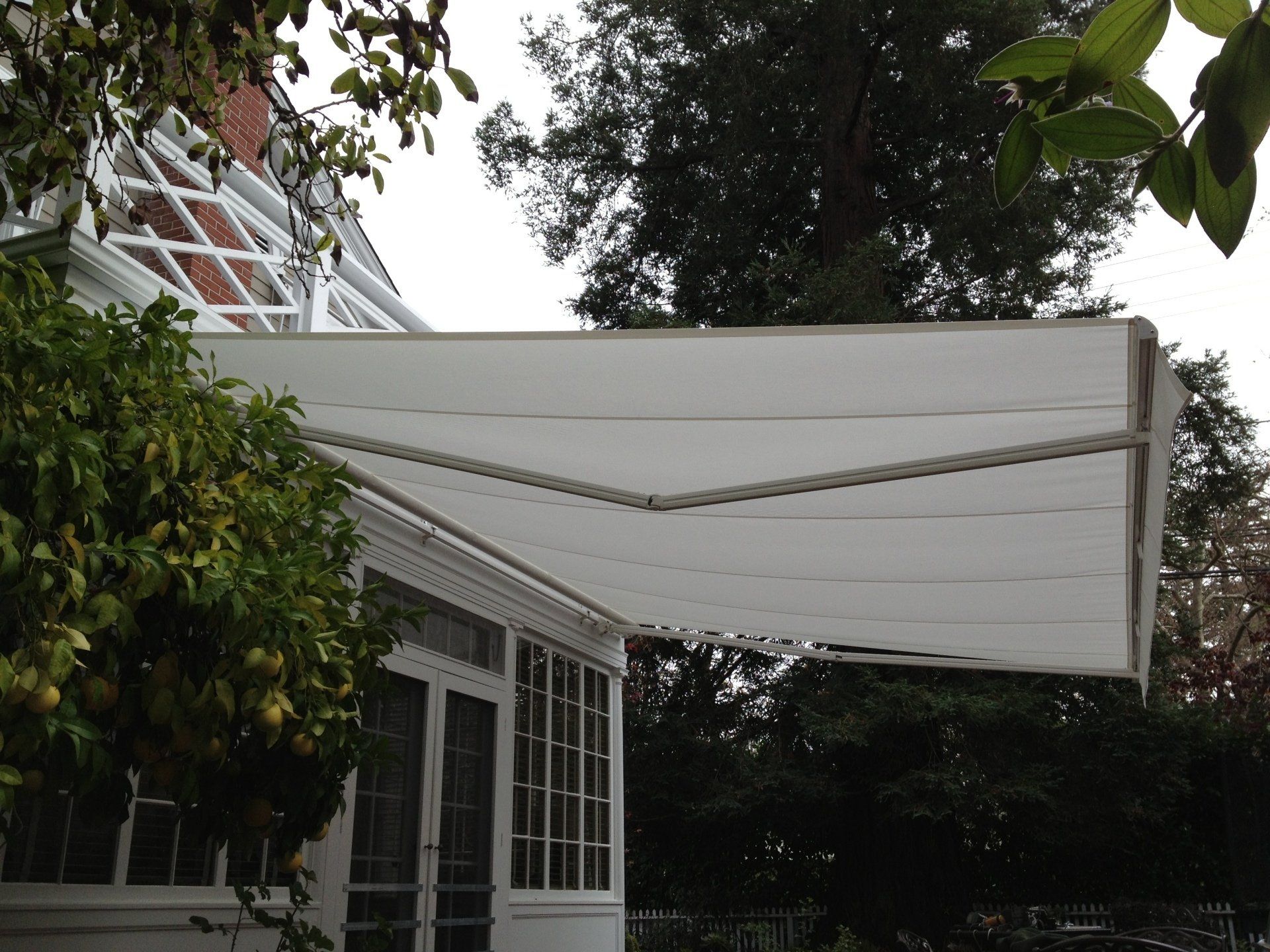 A white awning is on the side of a house