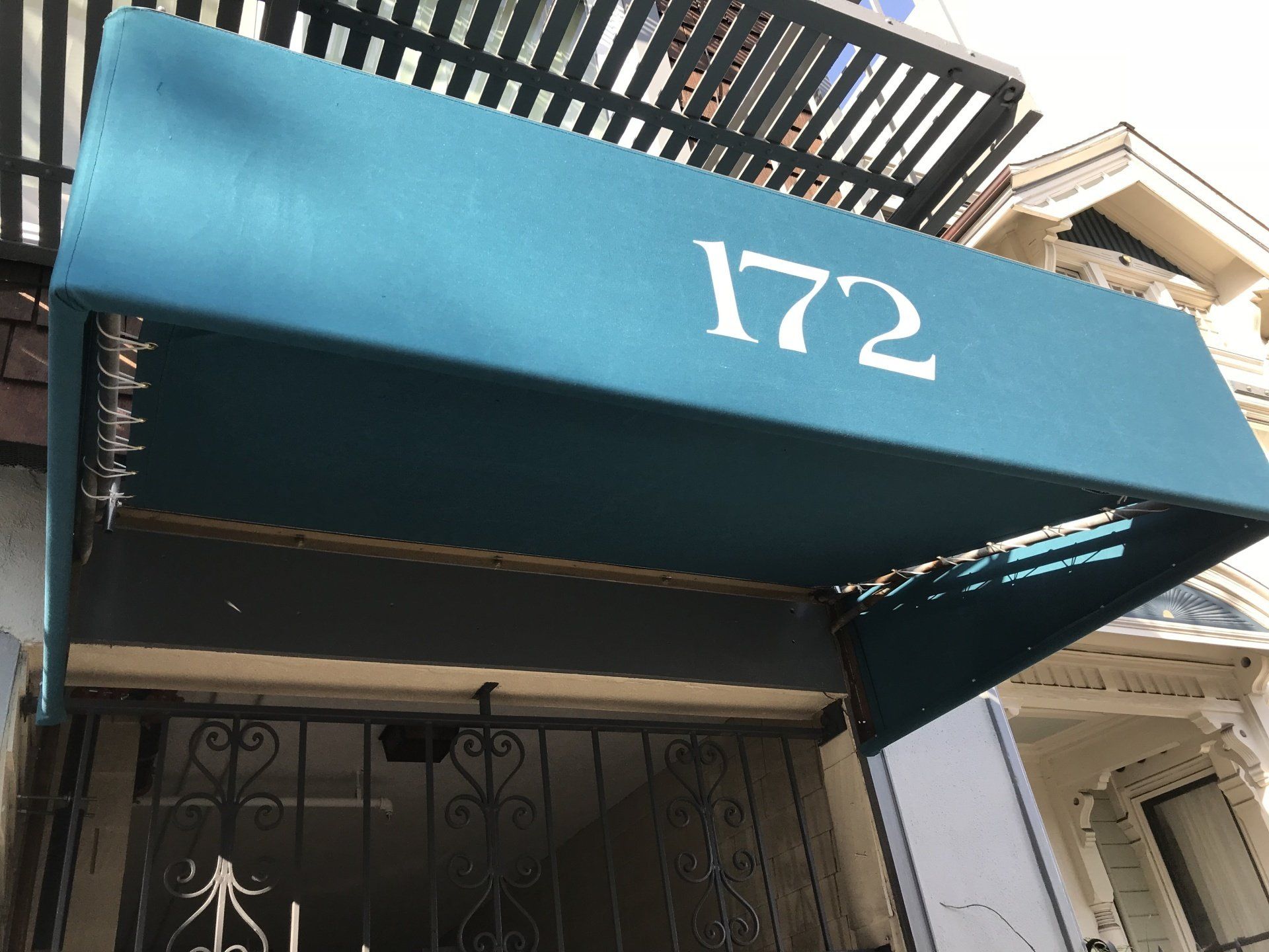 A blue awning with the number 172 on it