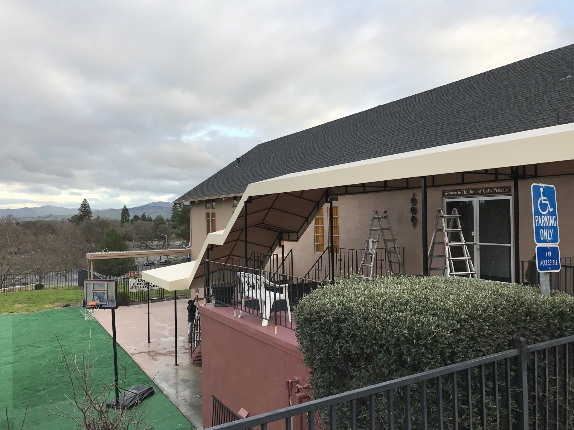 A large building with a handicapped parking sign in front of it.