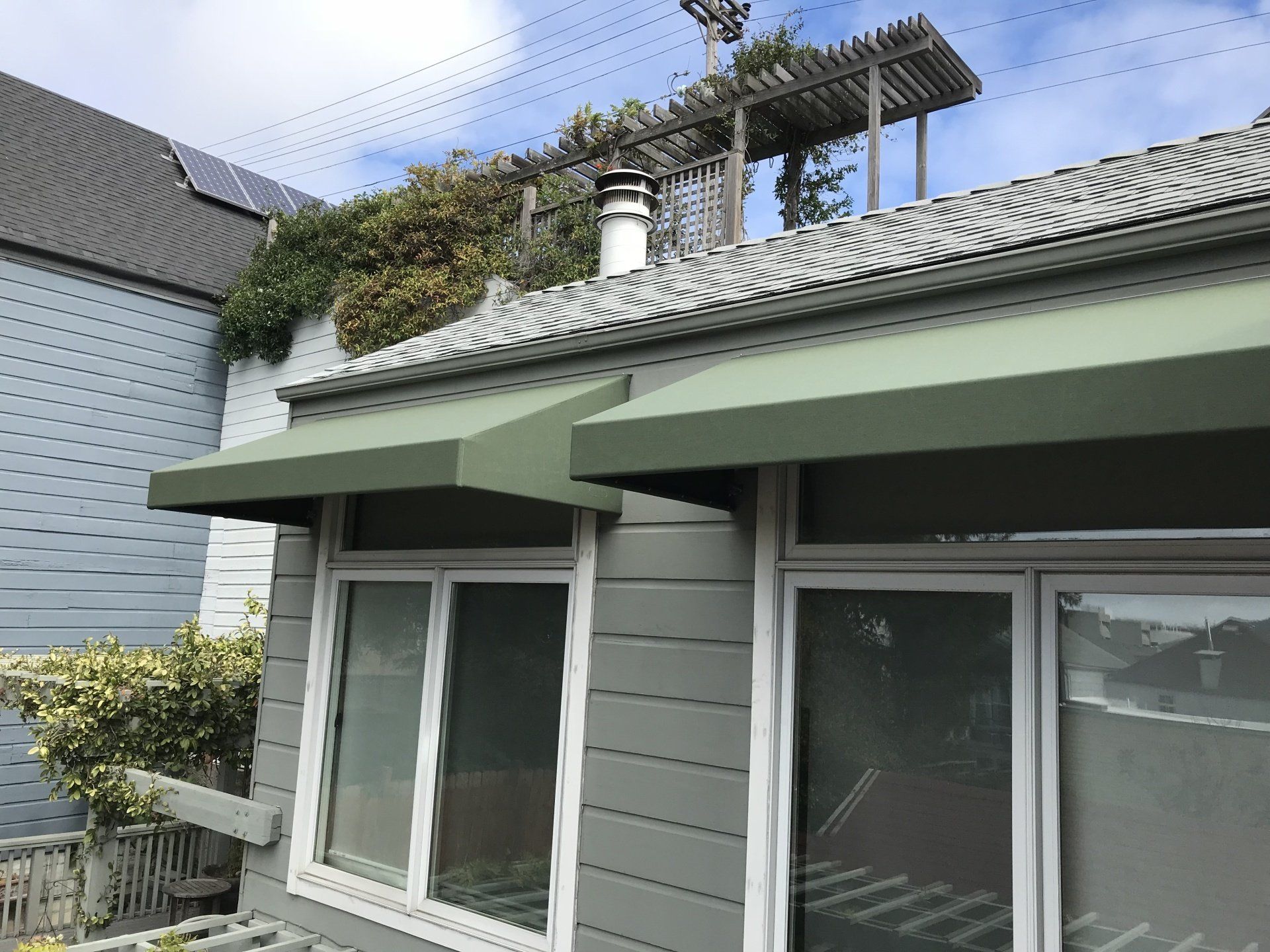A house with a green awning on the side of it