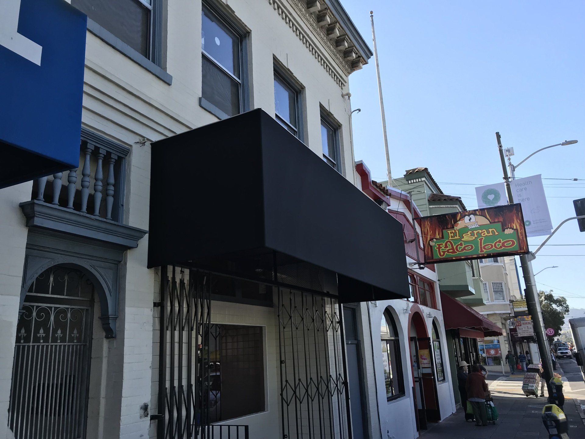 A building with a black awning on top of it