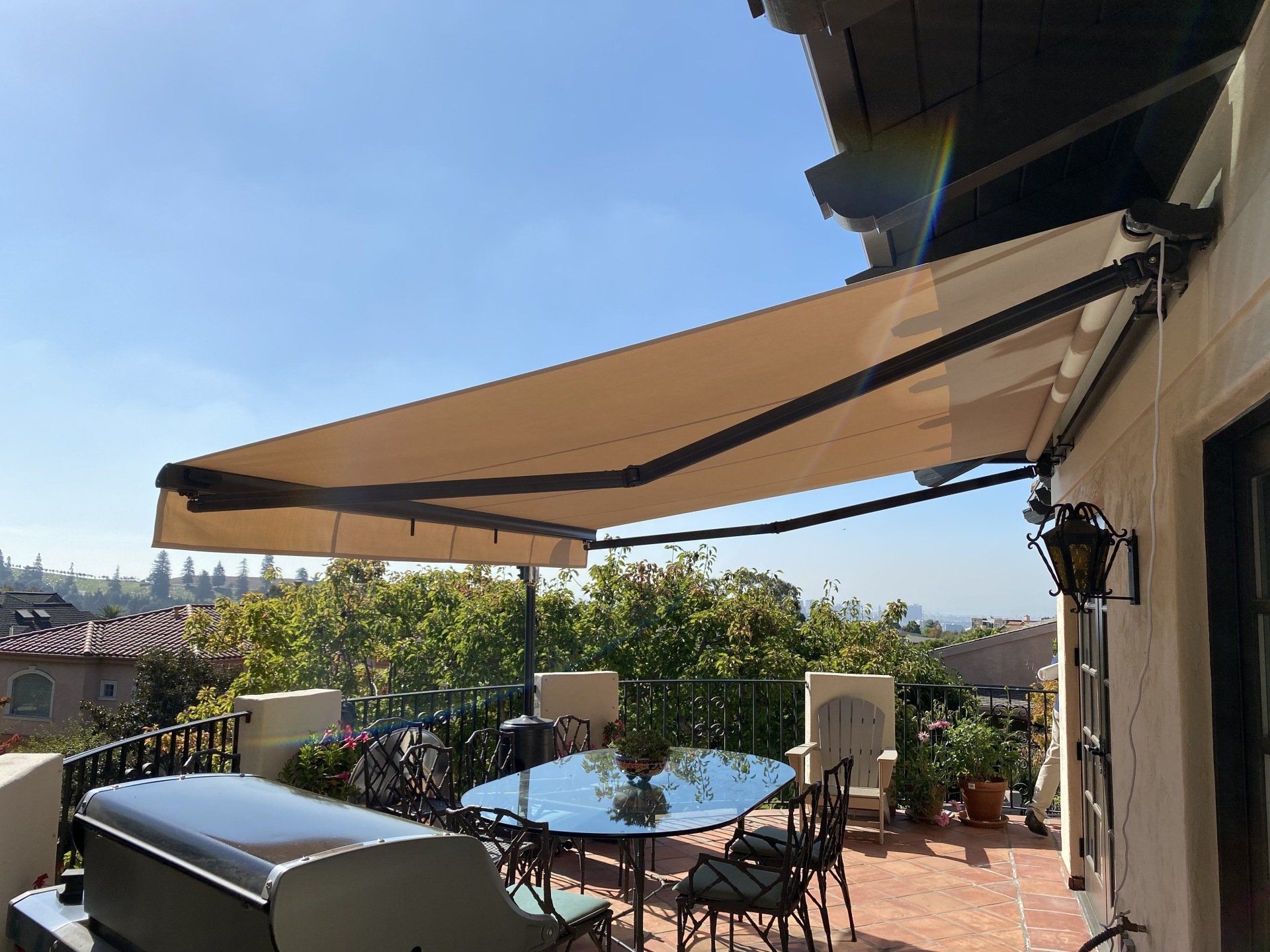 A patio with a table and chairs under an awning