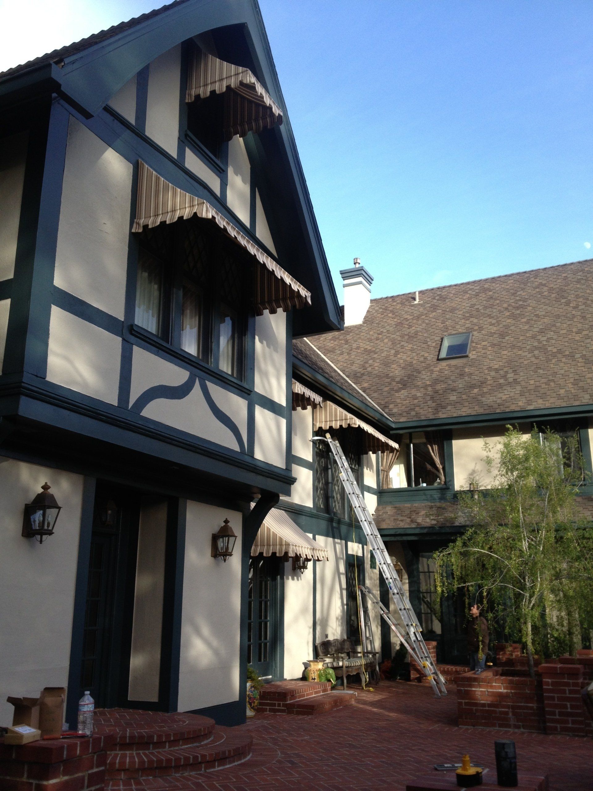 A large house with a ladder in front of it