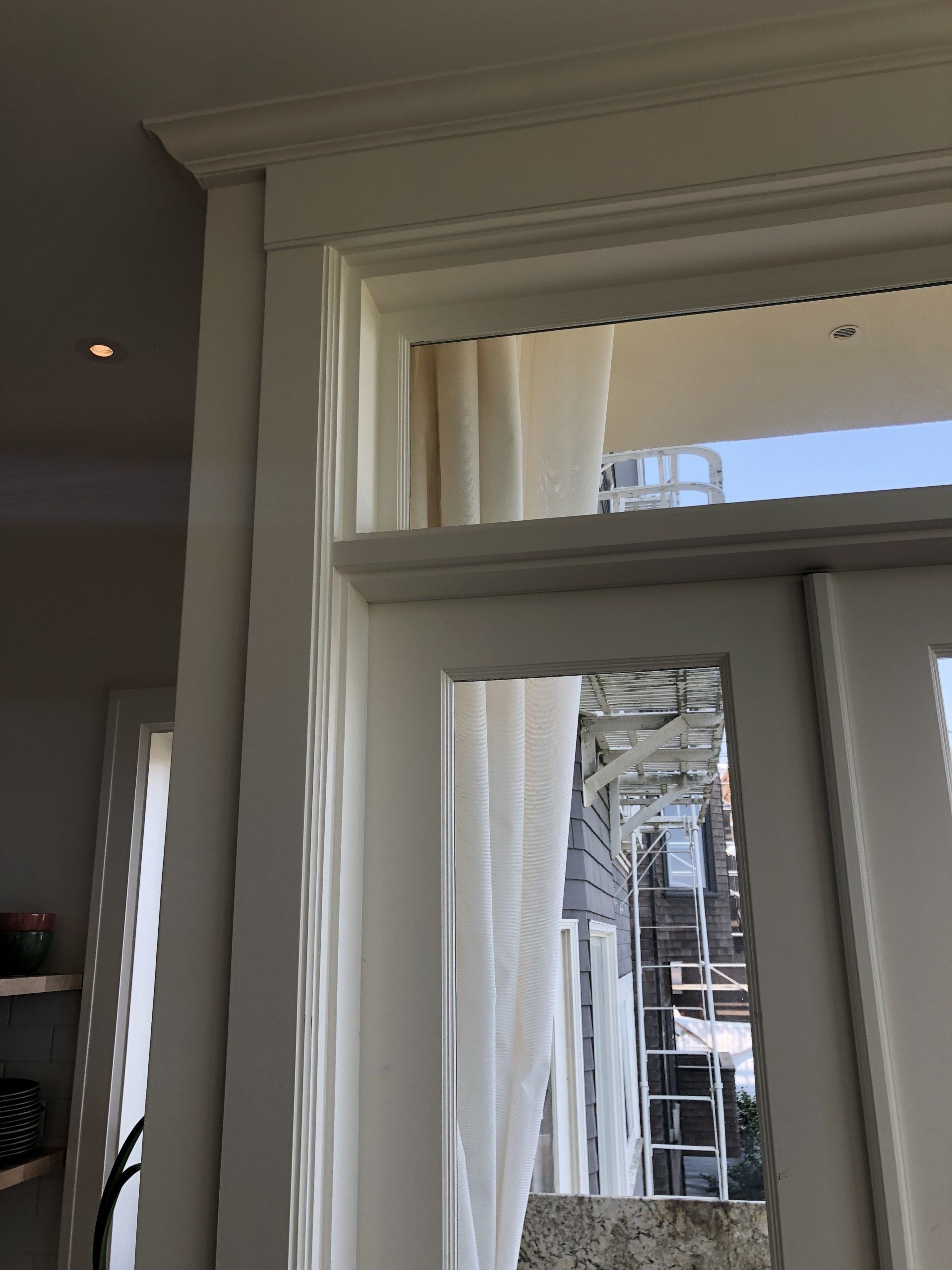 A window with a reflection of a building in it