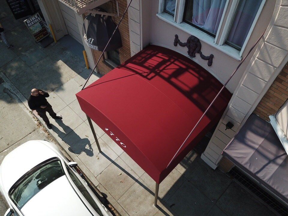 An aerial view of a building with a red awning