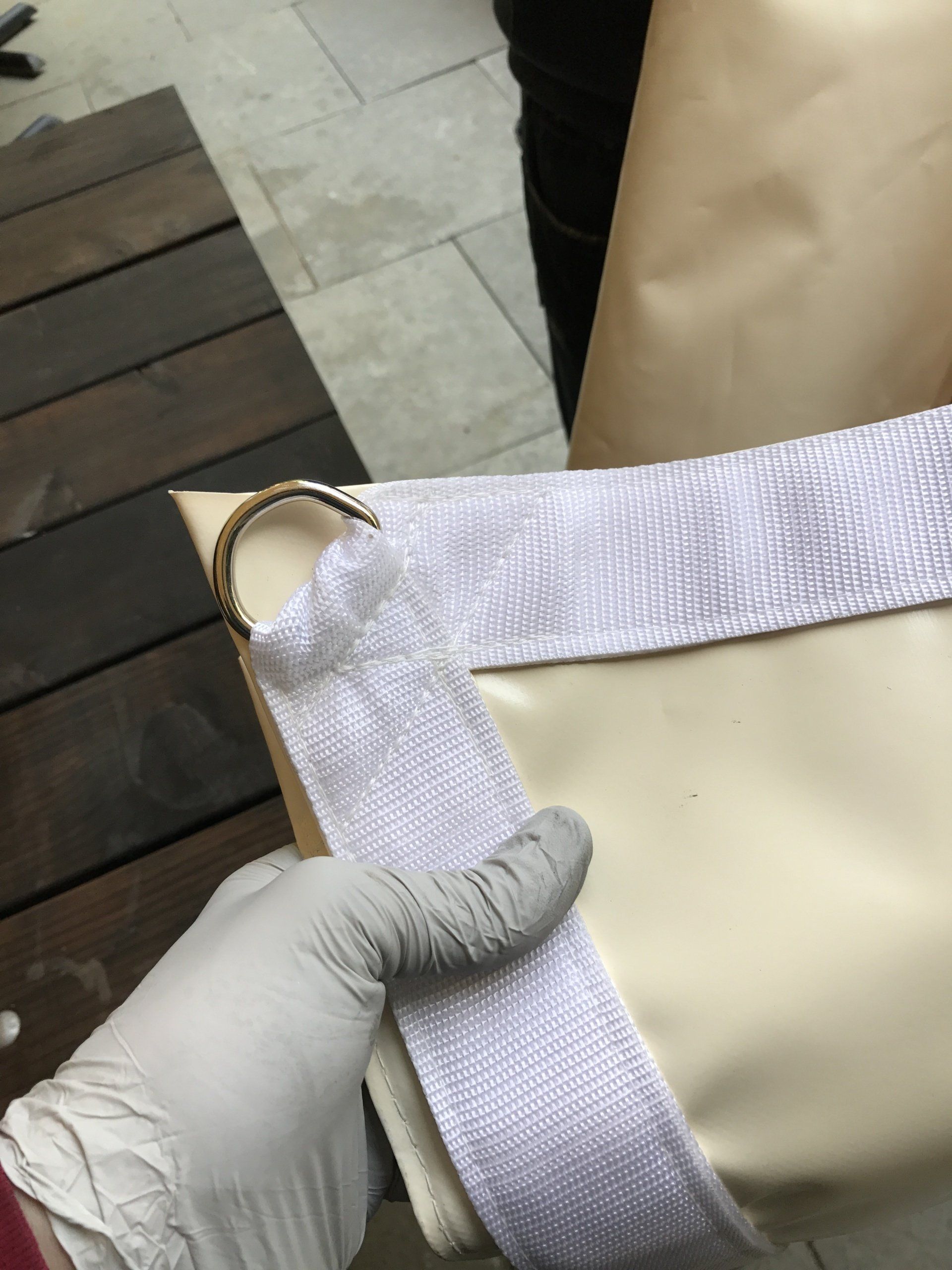 A person wearing gloves is holding a piece of fabric