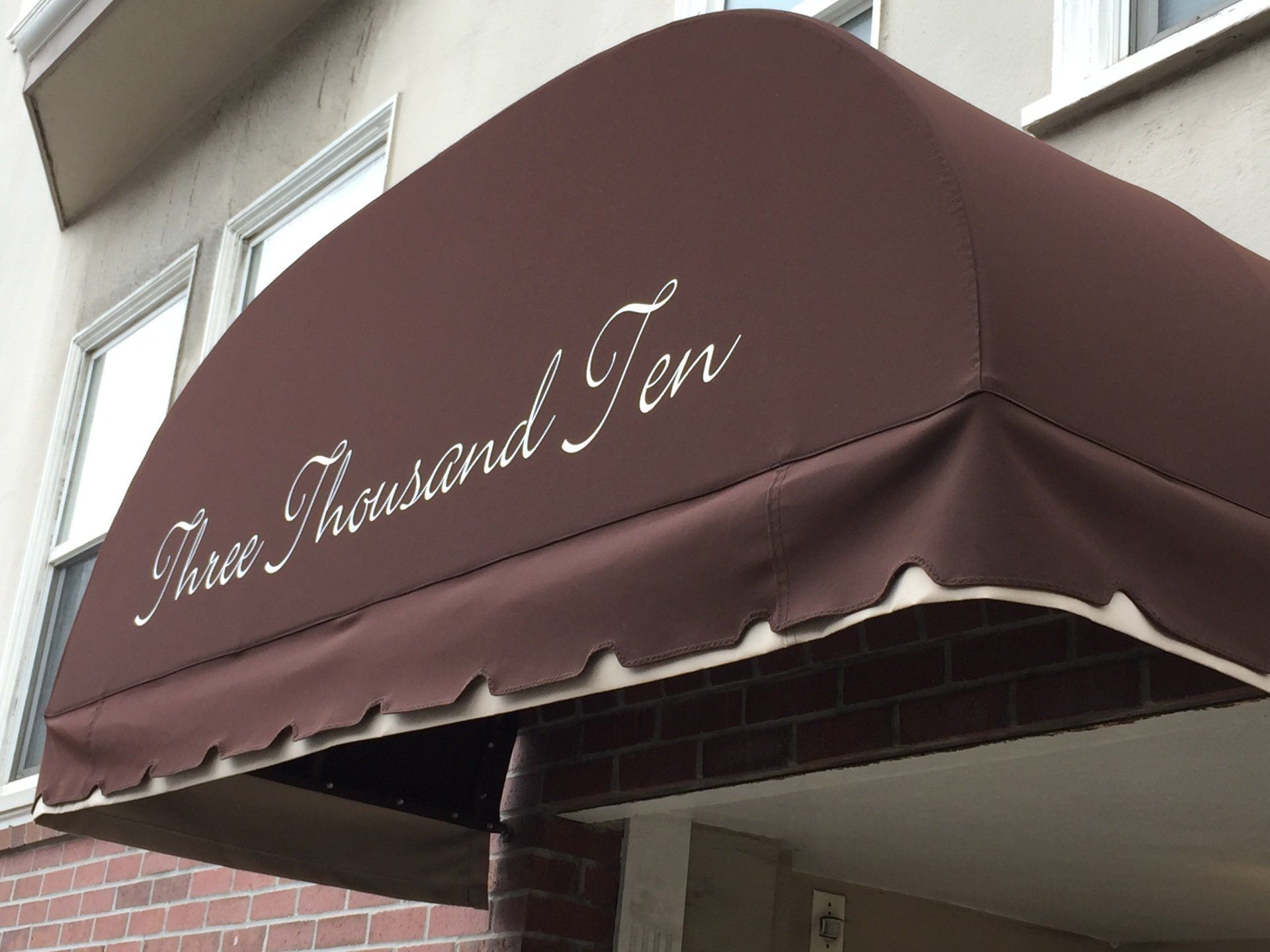 A brown awning with the words three thousand ten on it