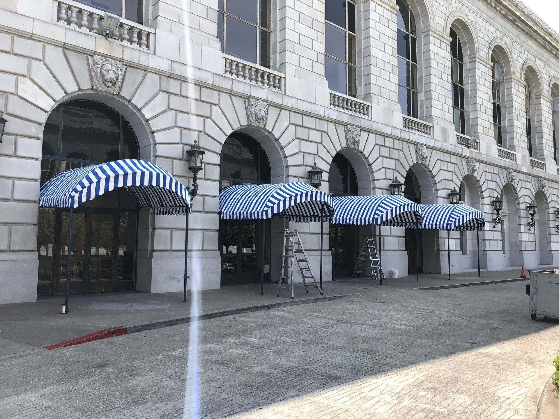 A large building with arches and canopies on the side of it.