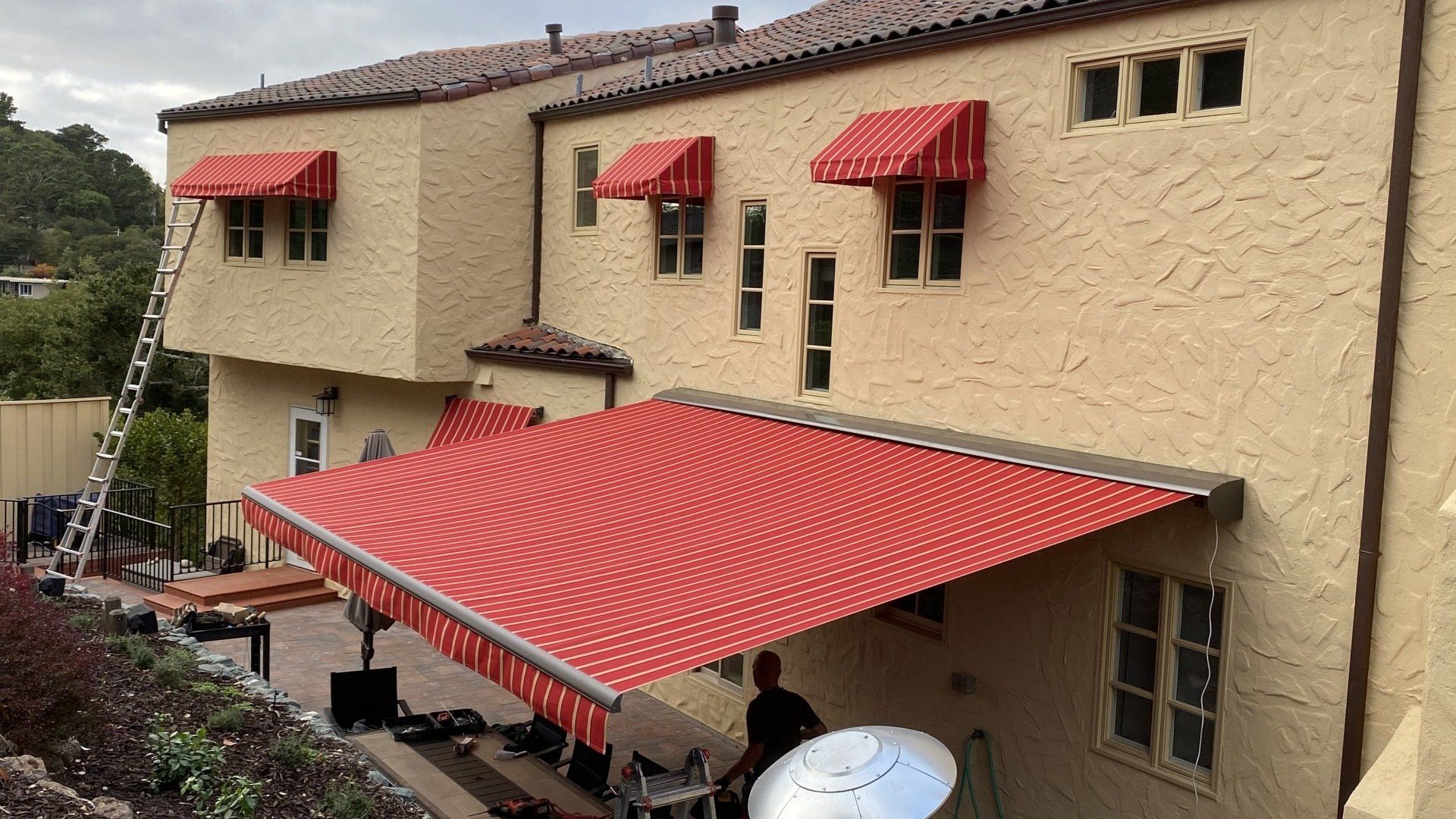 A house with a red awning on the side of it