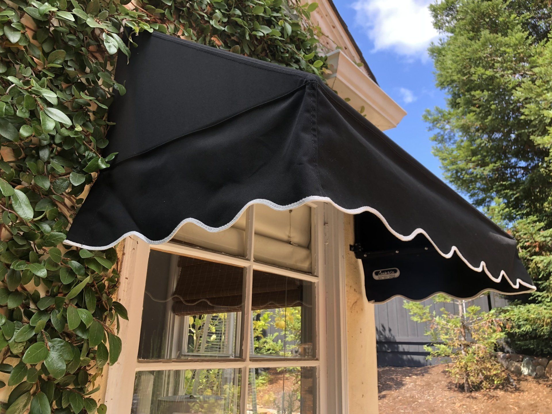 A window with a black awning on it