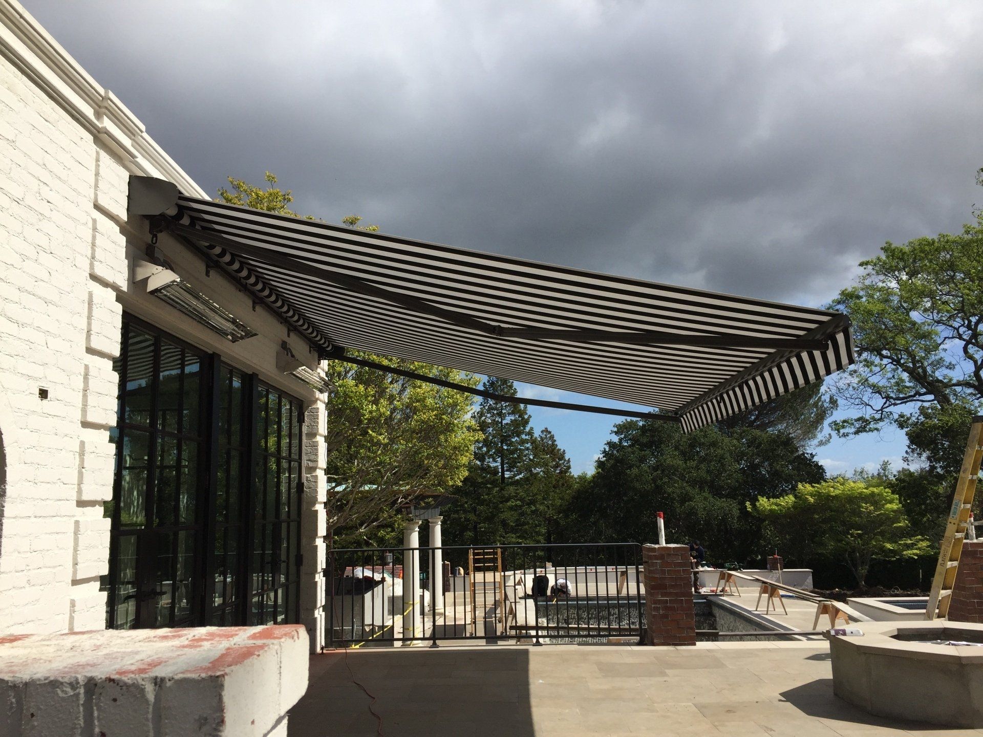 A black and white awning is on the side of a building.