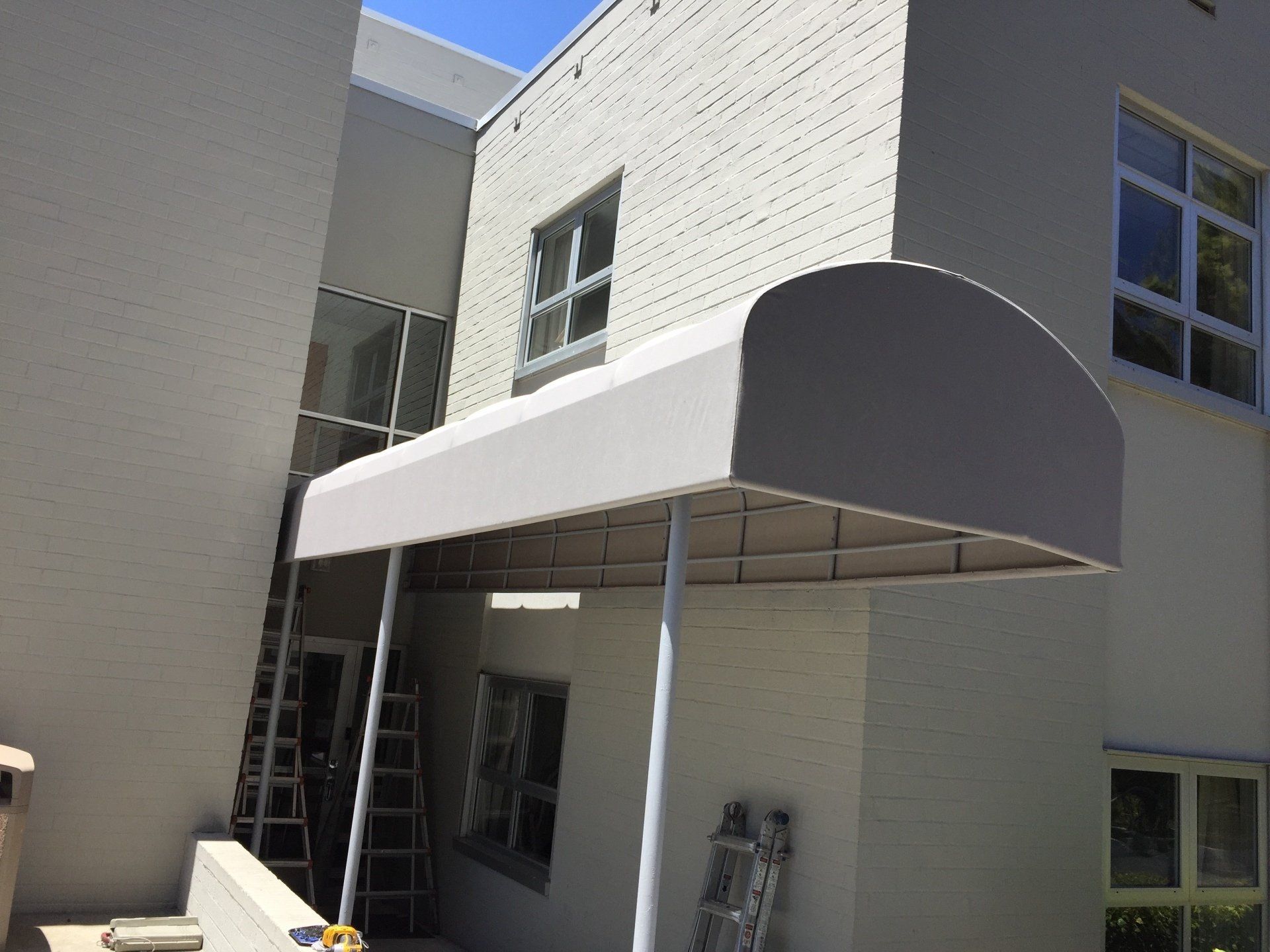 A white awning is on the side of a building
