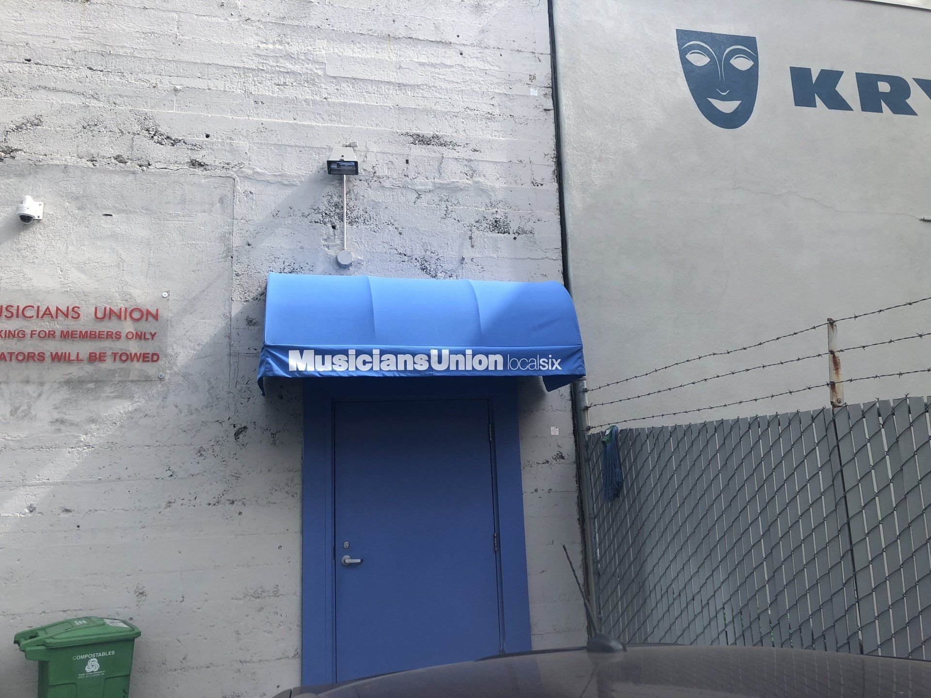 A blue door with a blue awning that says musicians union