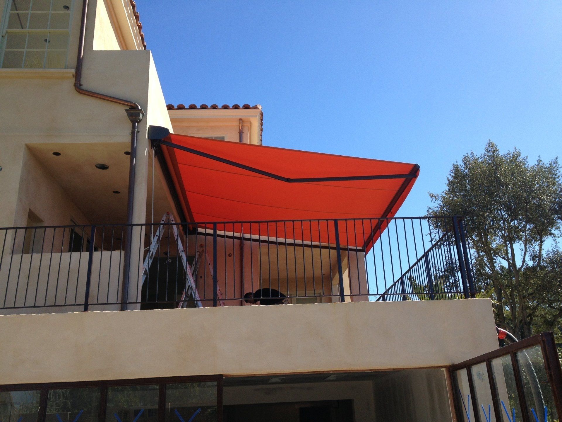 A balcony with a red awning over it