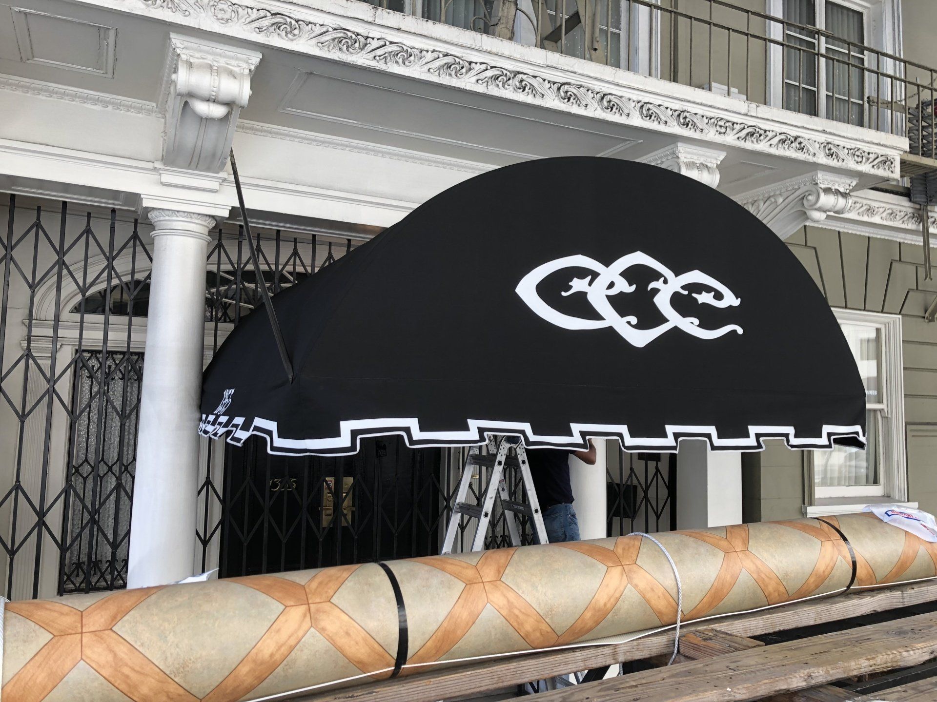 A black awning with the word cee on it