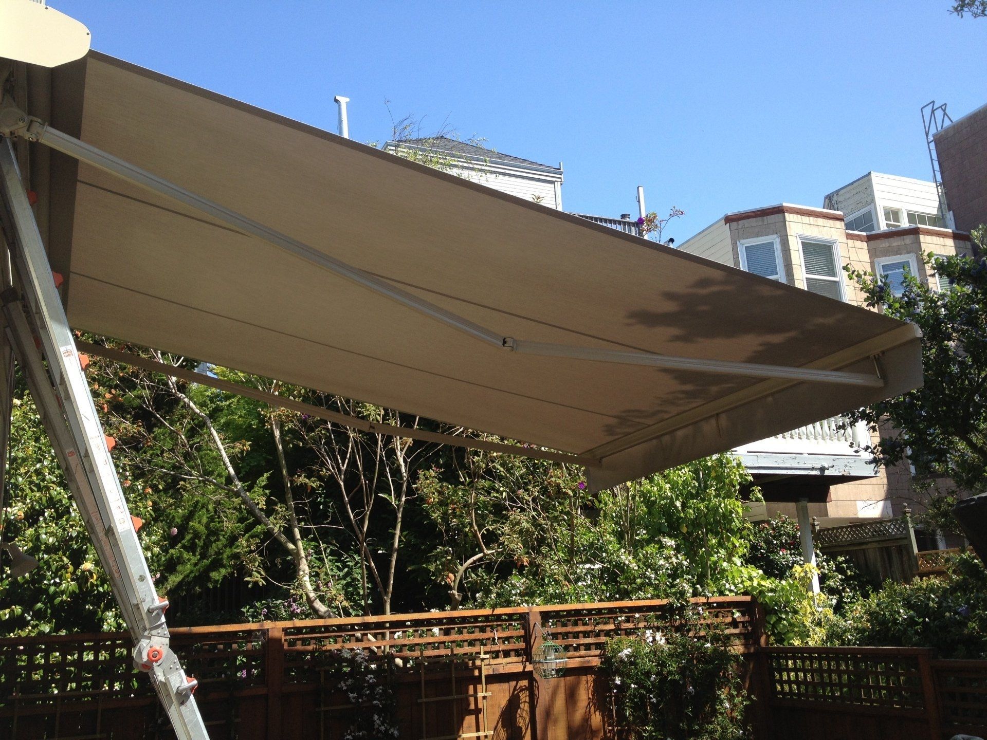 A large awning is hanging over a wooden deck