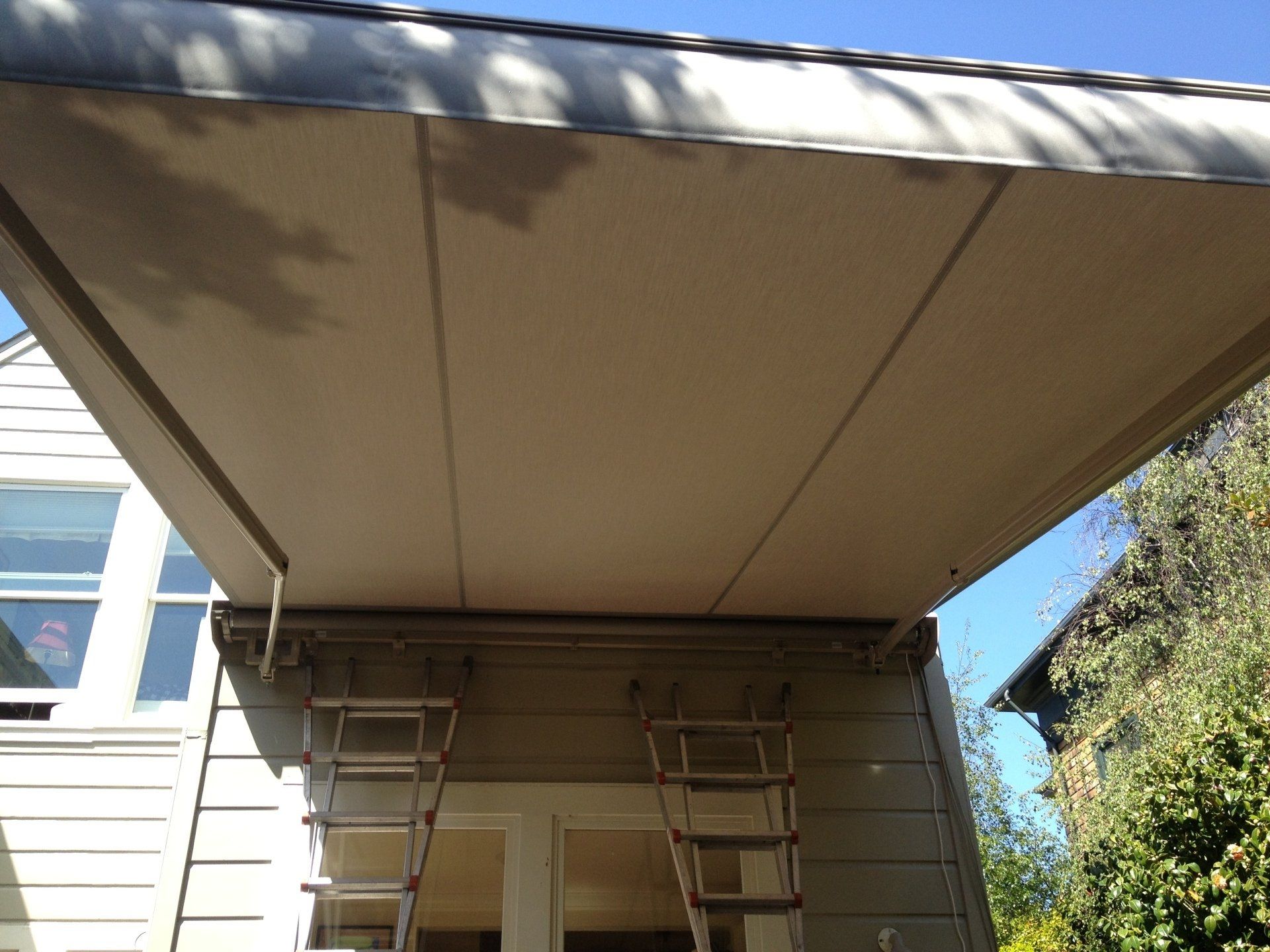 A ladder is hanging from the roof of a house