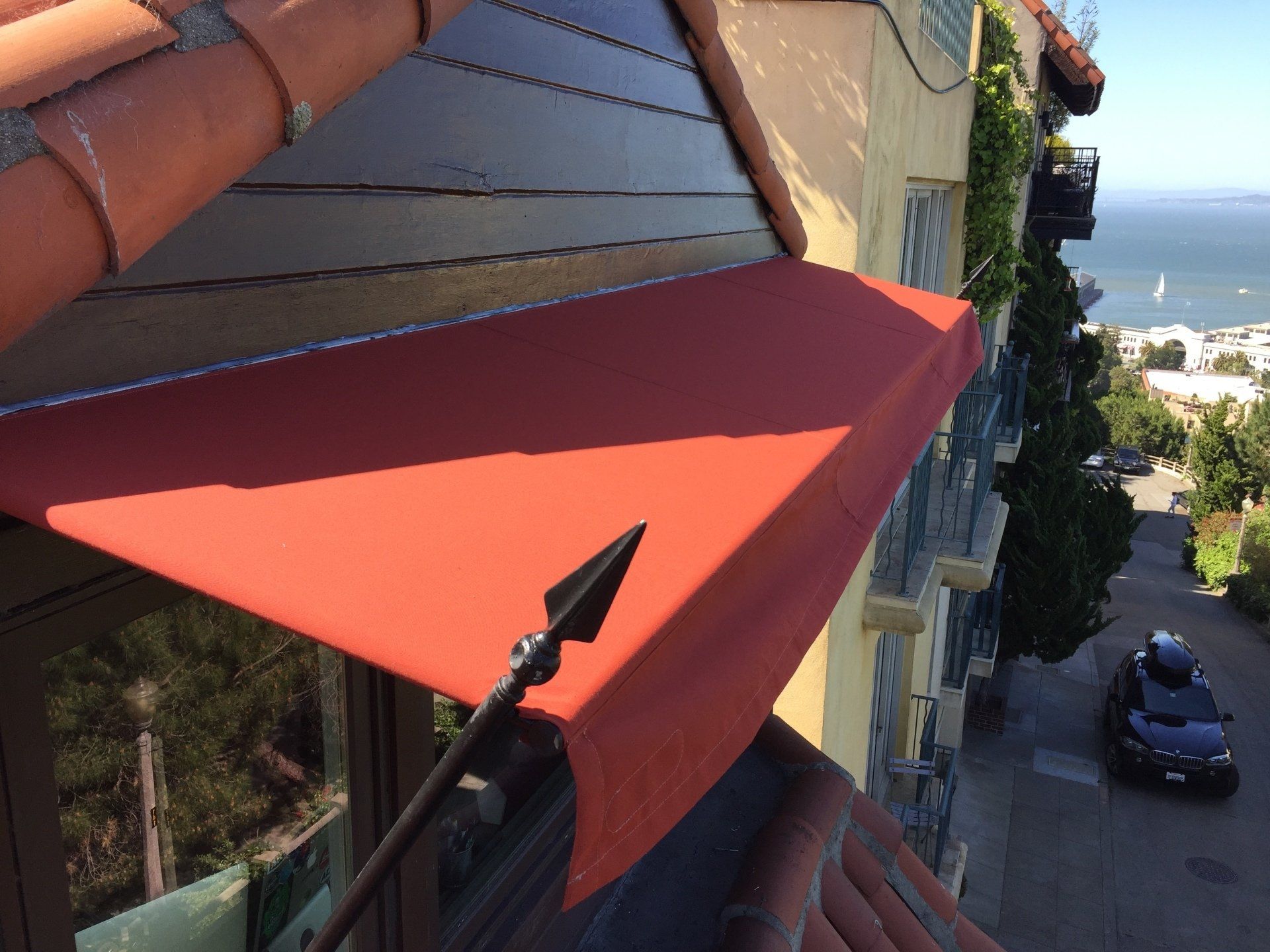 A red awning is on the side of a building
