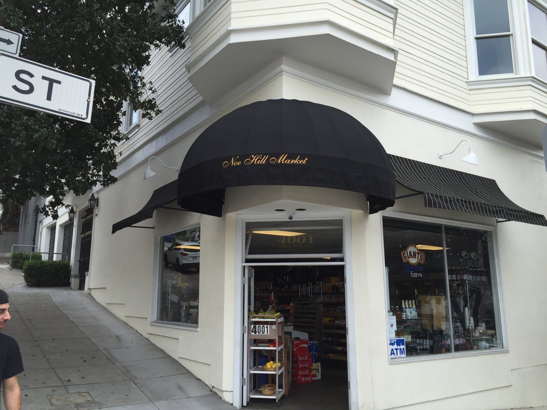 A store front with a black awning on it