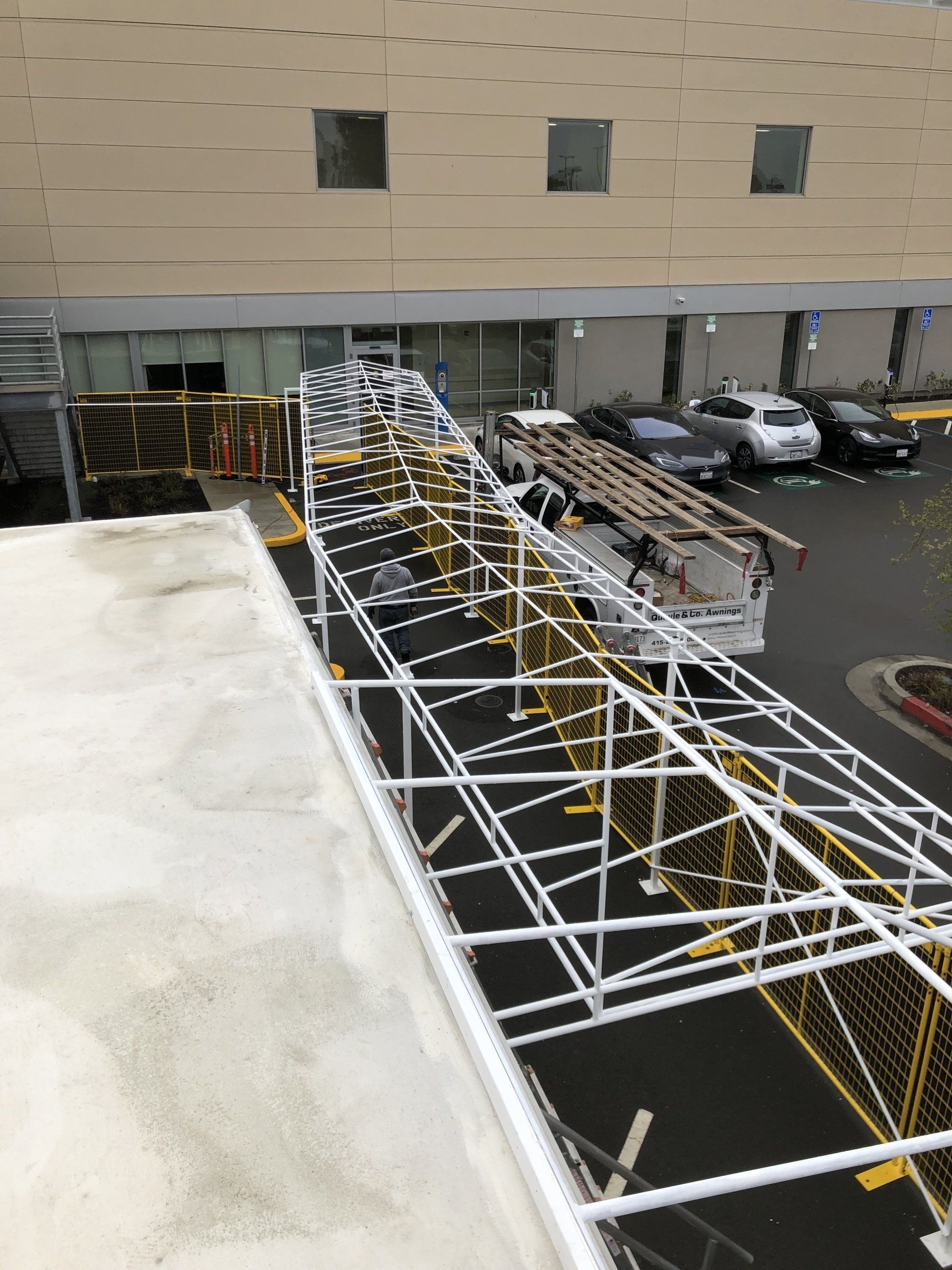 A view of a parking lot from the roof of a building