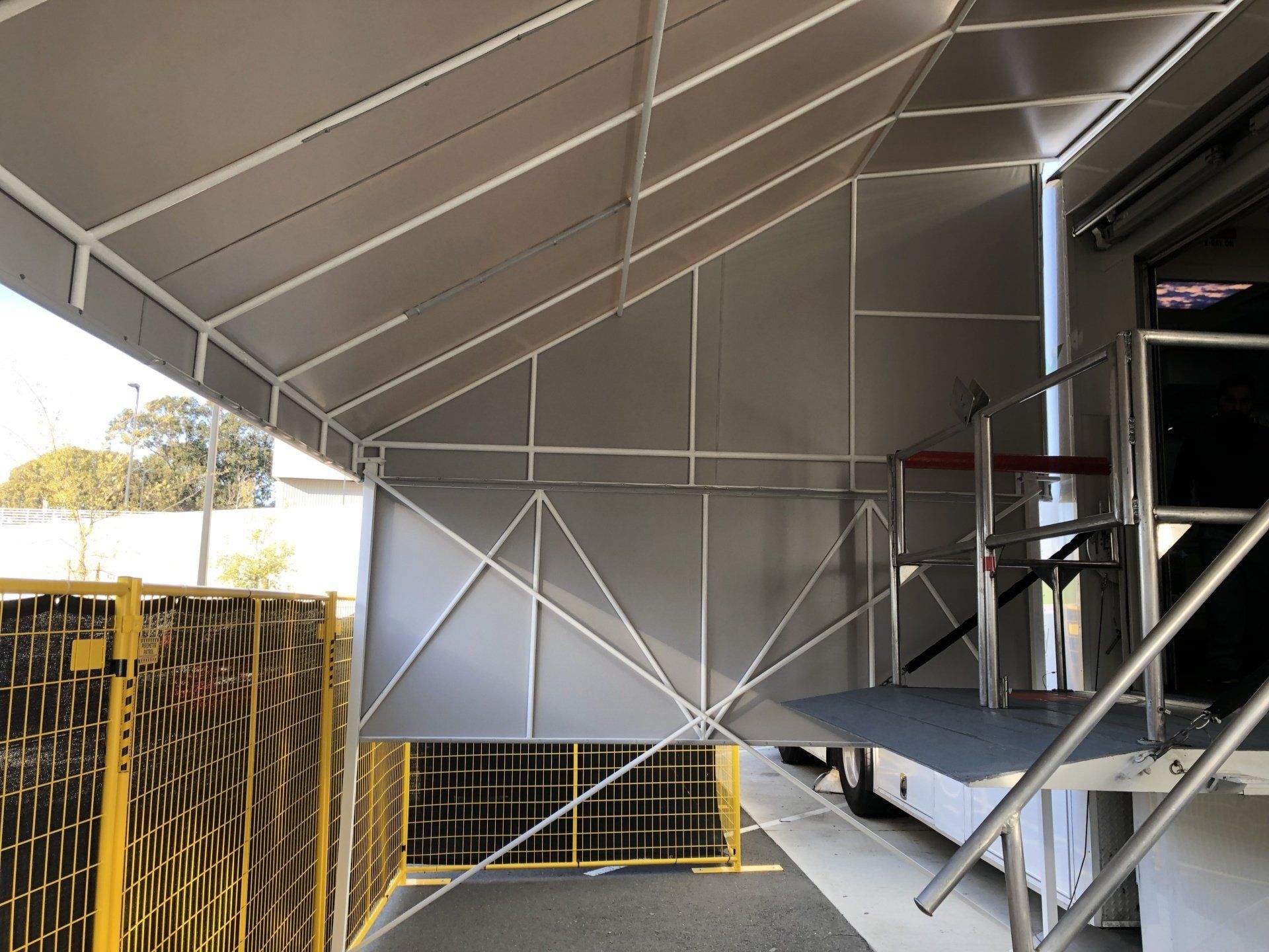 A staircase leading up to a building with a canopy over it.
