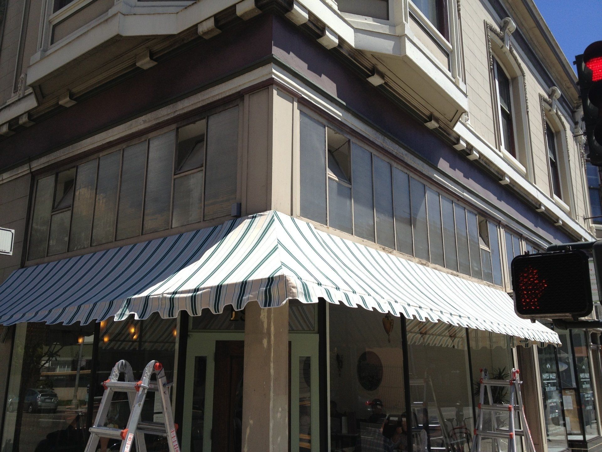 A store front with a striped awning on it