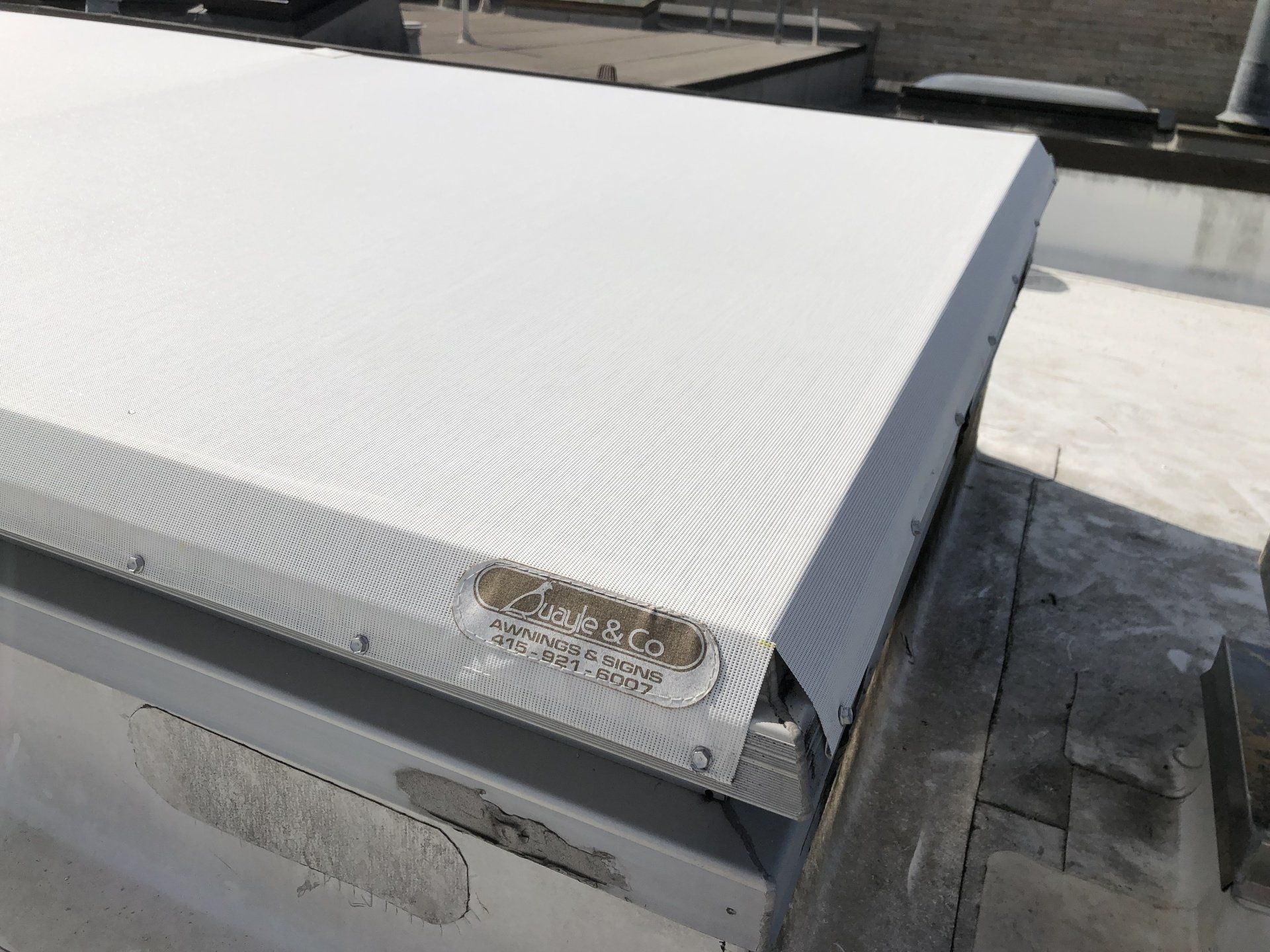 A white box is sitting on top of a roof.