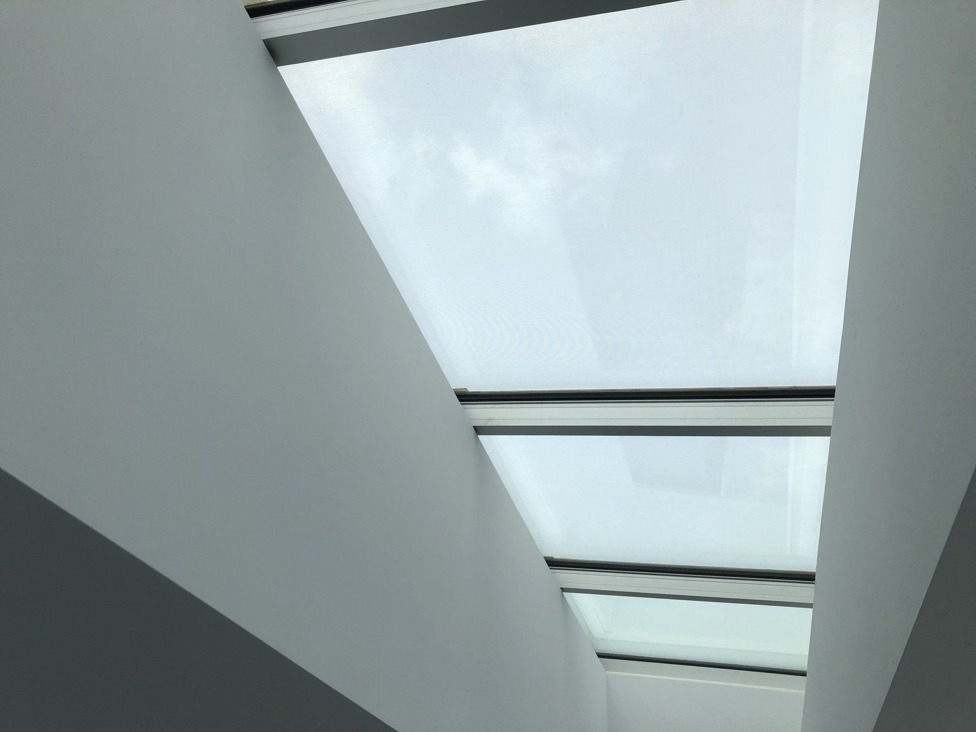 Looking up at the sky through a skylight in a building