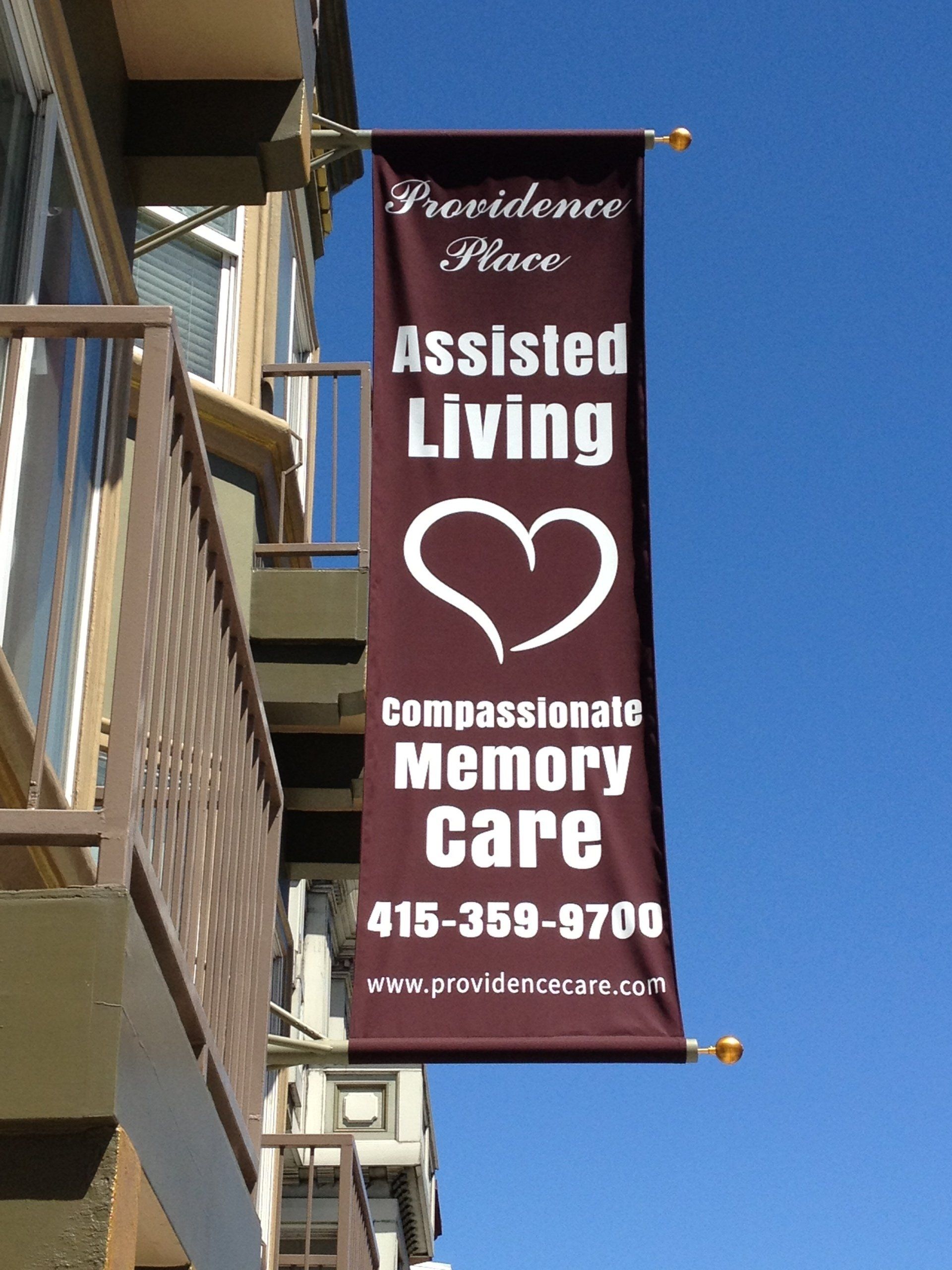 A banner on the side of a building that says assisted living
