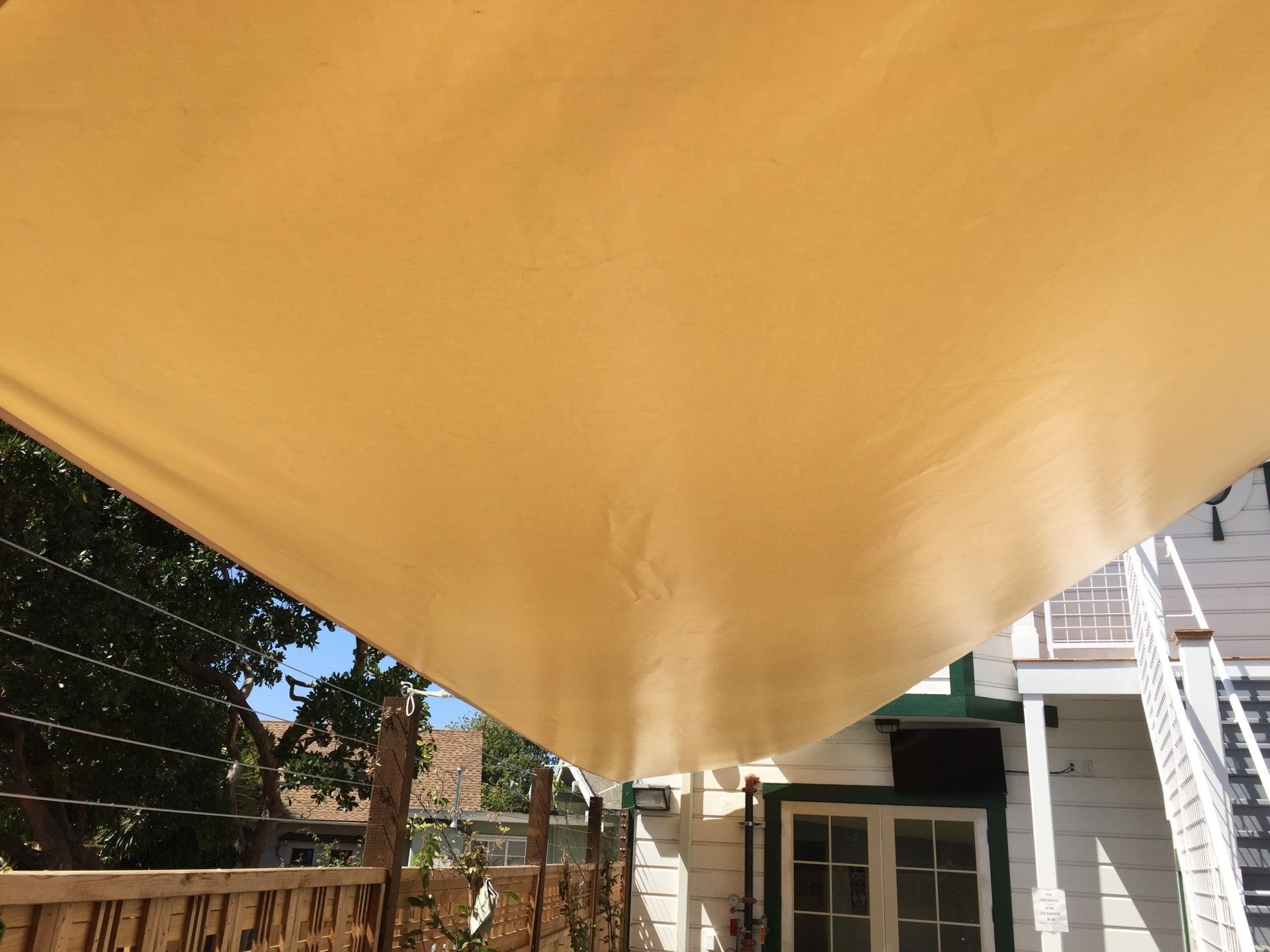A large piece of fabric is hanging from the ceiling of a house.