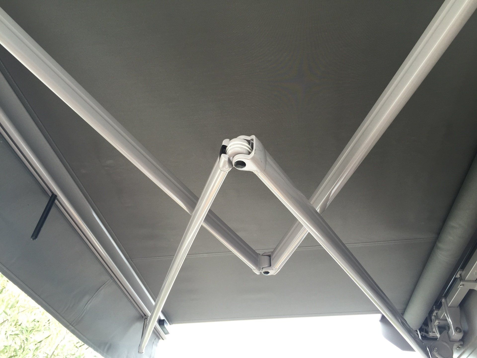 A close up of a gray awning with a white frame