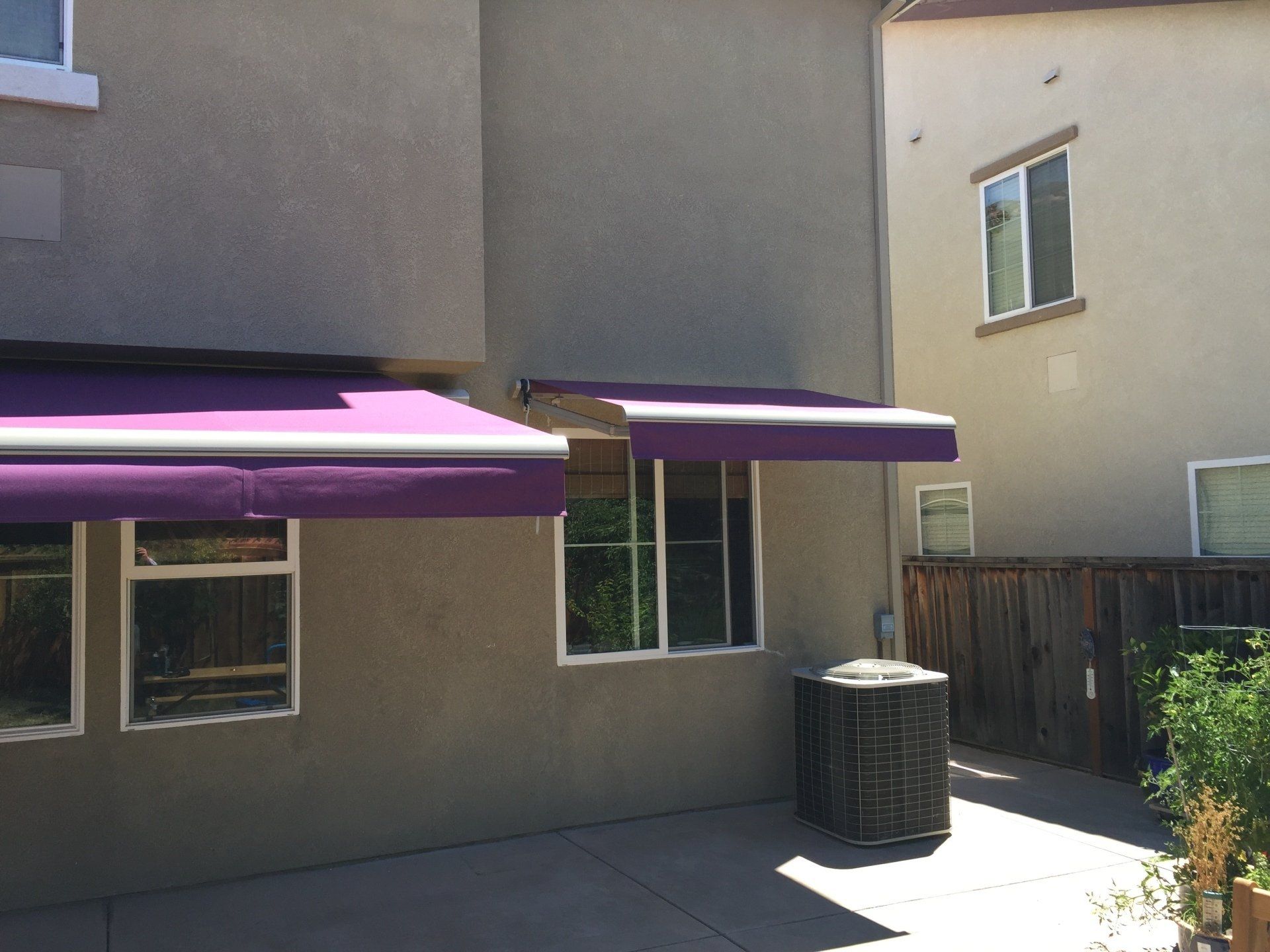 A house with a purple awning on the side of it