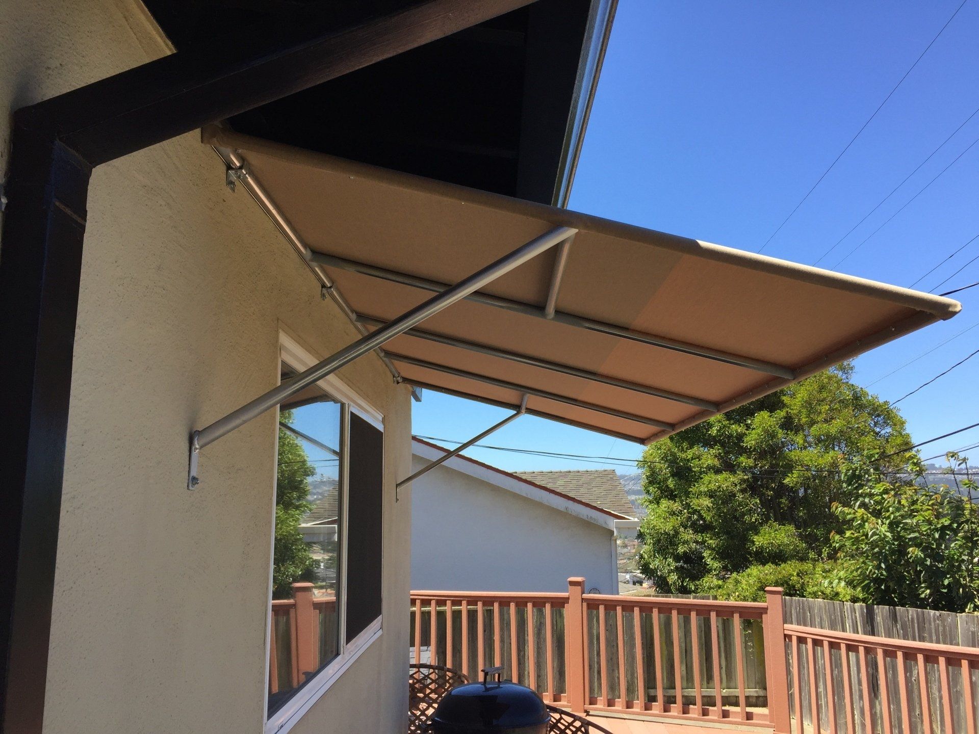 A house with a balcony and a canopy over it