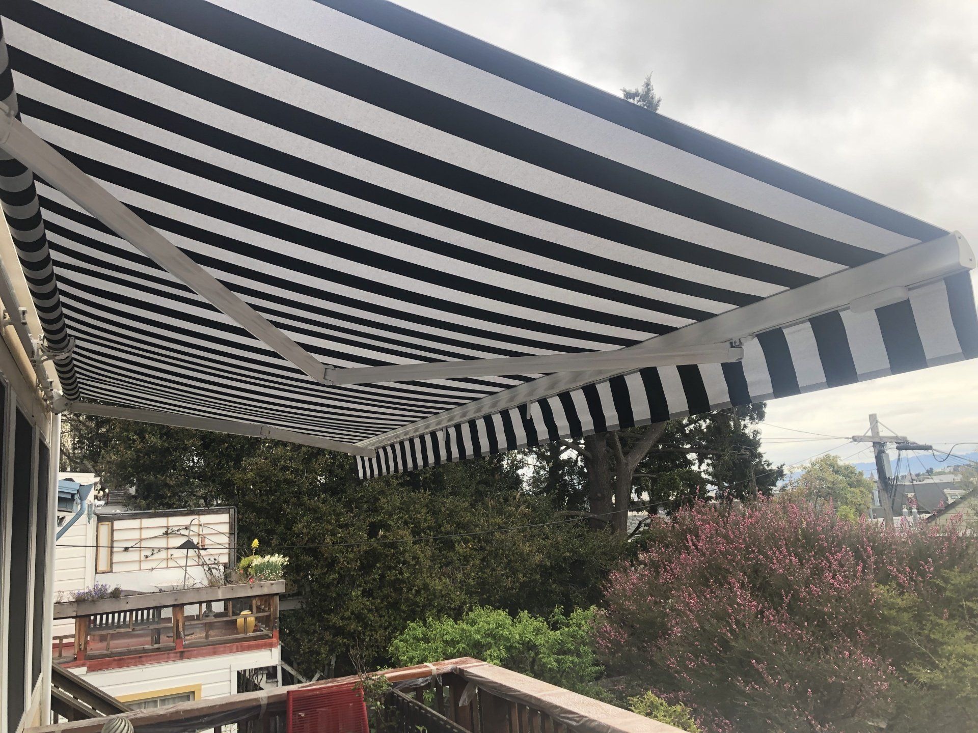 A black and white striped awning is hanging over a balcony.