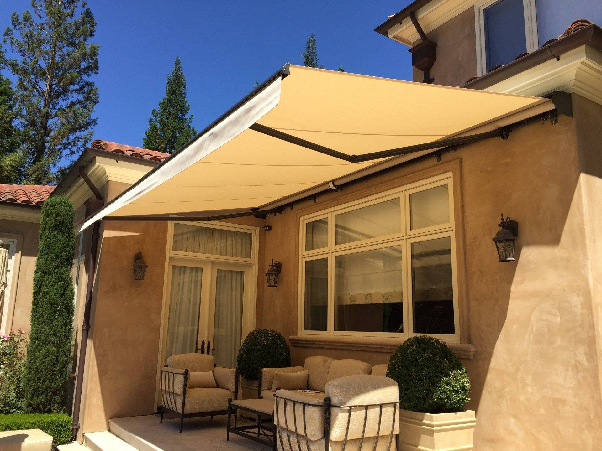A house with a patio with a canopy over it