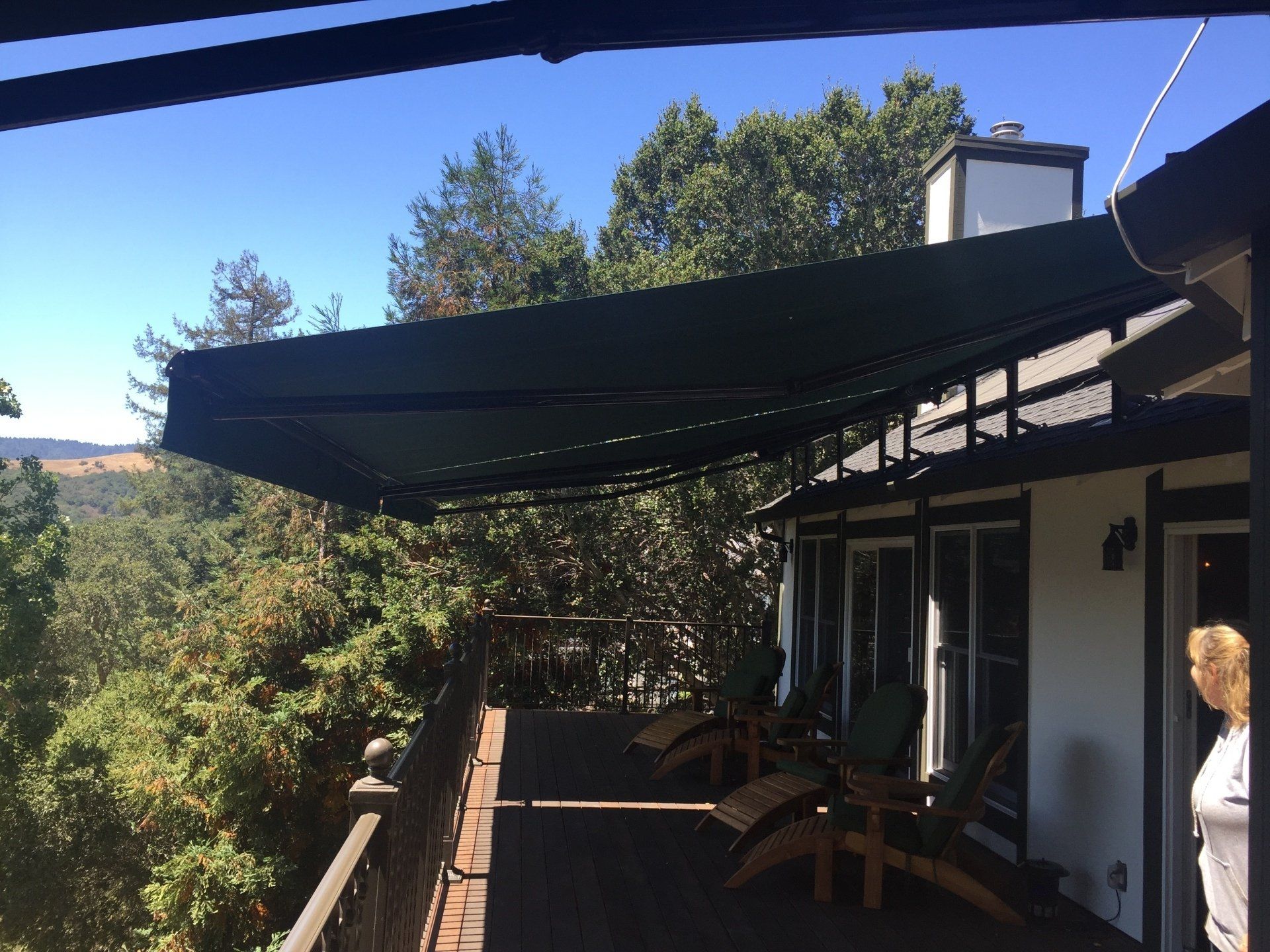 A large deck with a black awning over it